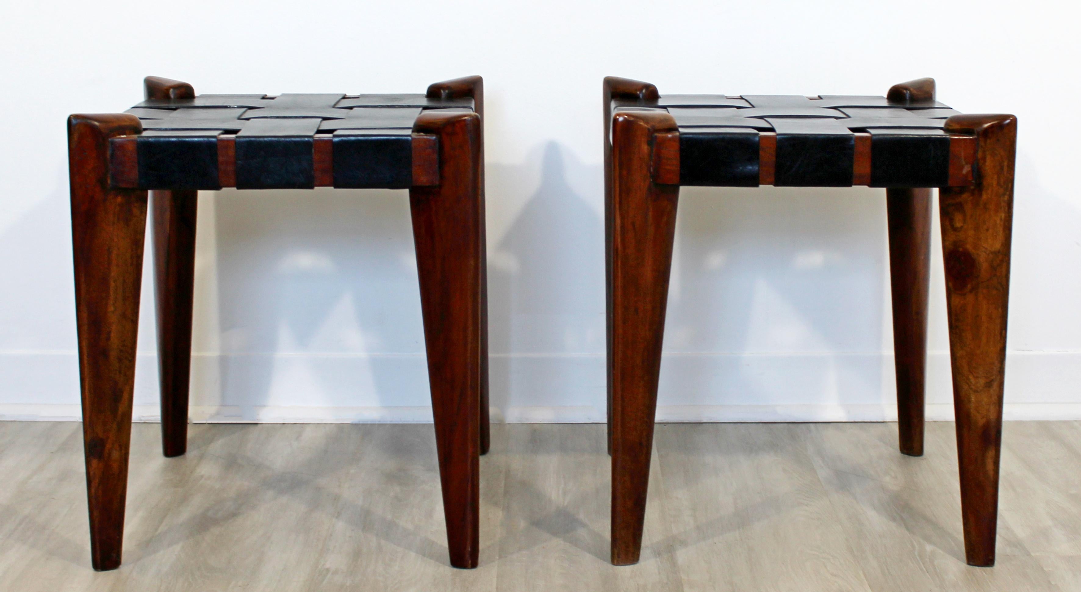 For your consideration is a rare pair of ebonized wood bench stools, with woven black leather seats, by Edmund Spence, circa 1960s. In excellent vintage condition. The dimensions of each are 16