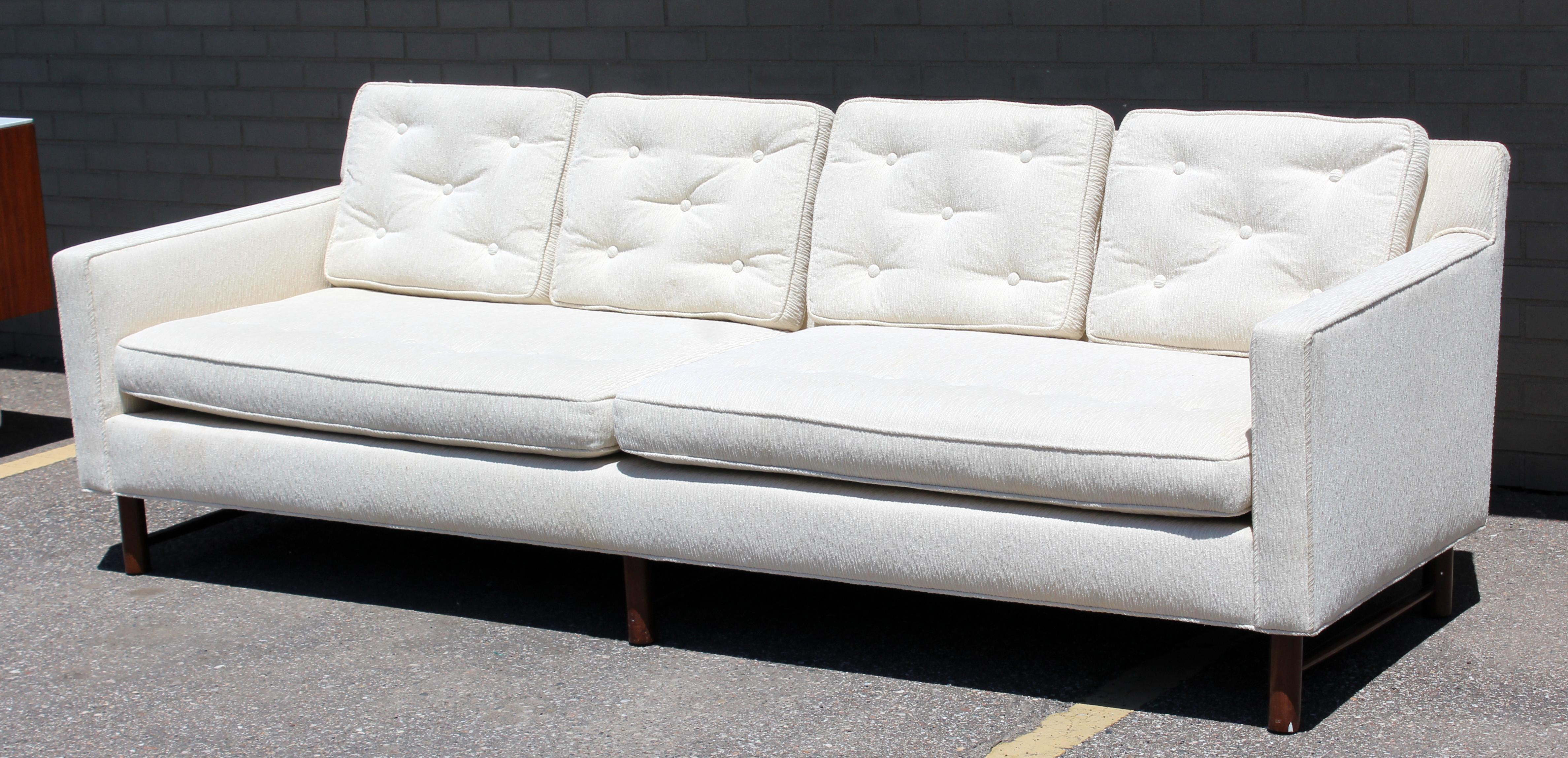 For your consideration is a fantastic, tufted, white sofa, on wooden legs, by Edward Wormley for Dunbar, model # 4907, circa 1960s. In very good condition. The dimensions are 90