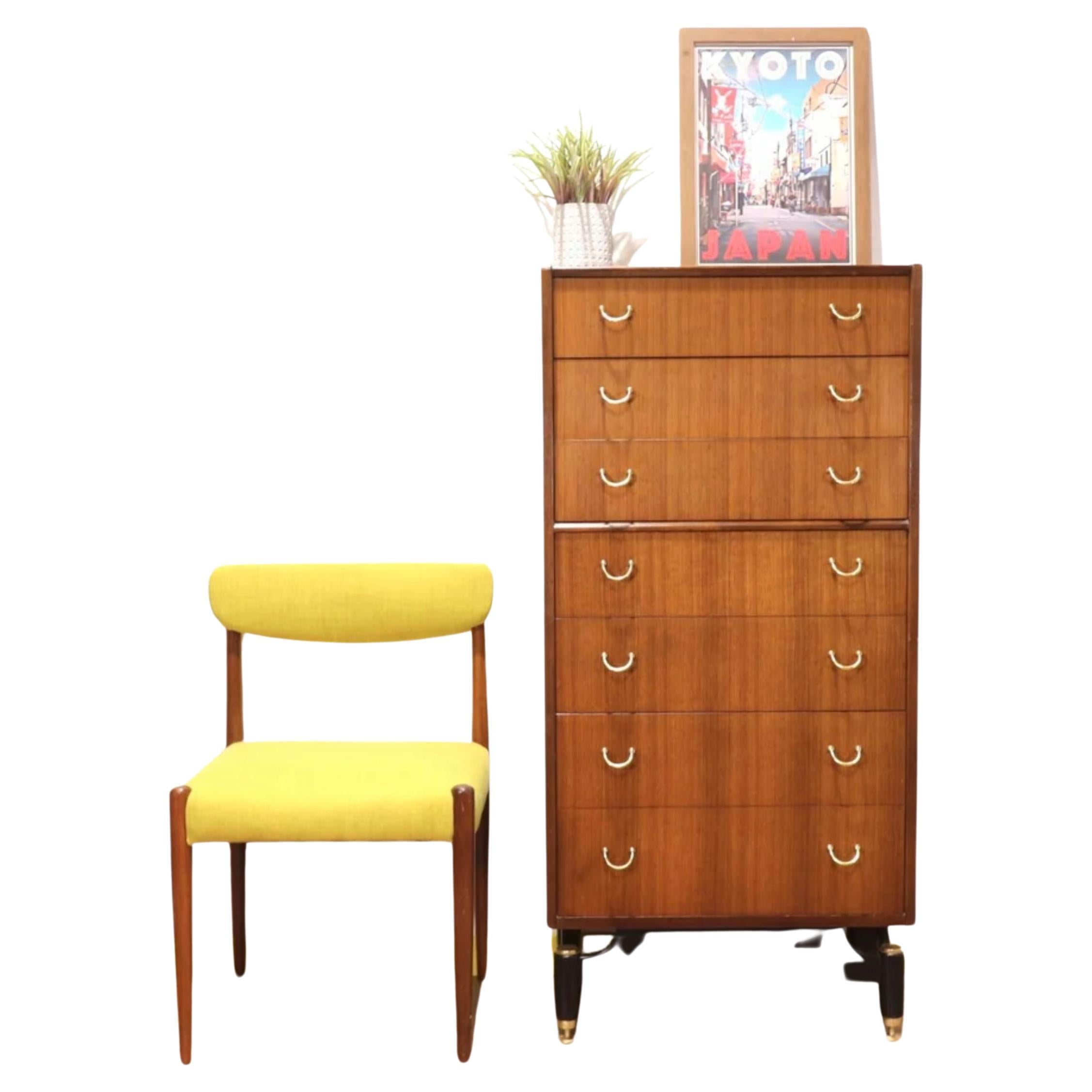 A stunning mid-century Italian style Tola Librenza tallboy dresser of 7 drawers By E Gomme (G Plan) on black plinth / legs with polished brass caps, adjustable brass riser feet & ergonomic curved brass handles.
Dimension:

W 24 D 16 H