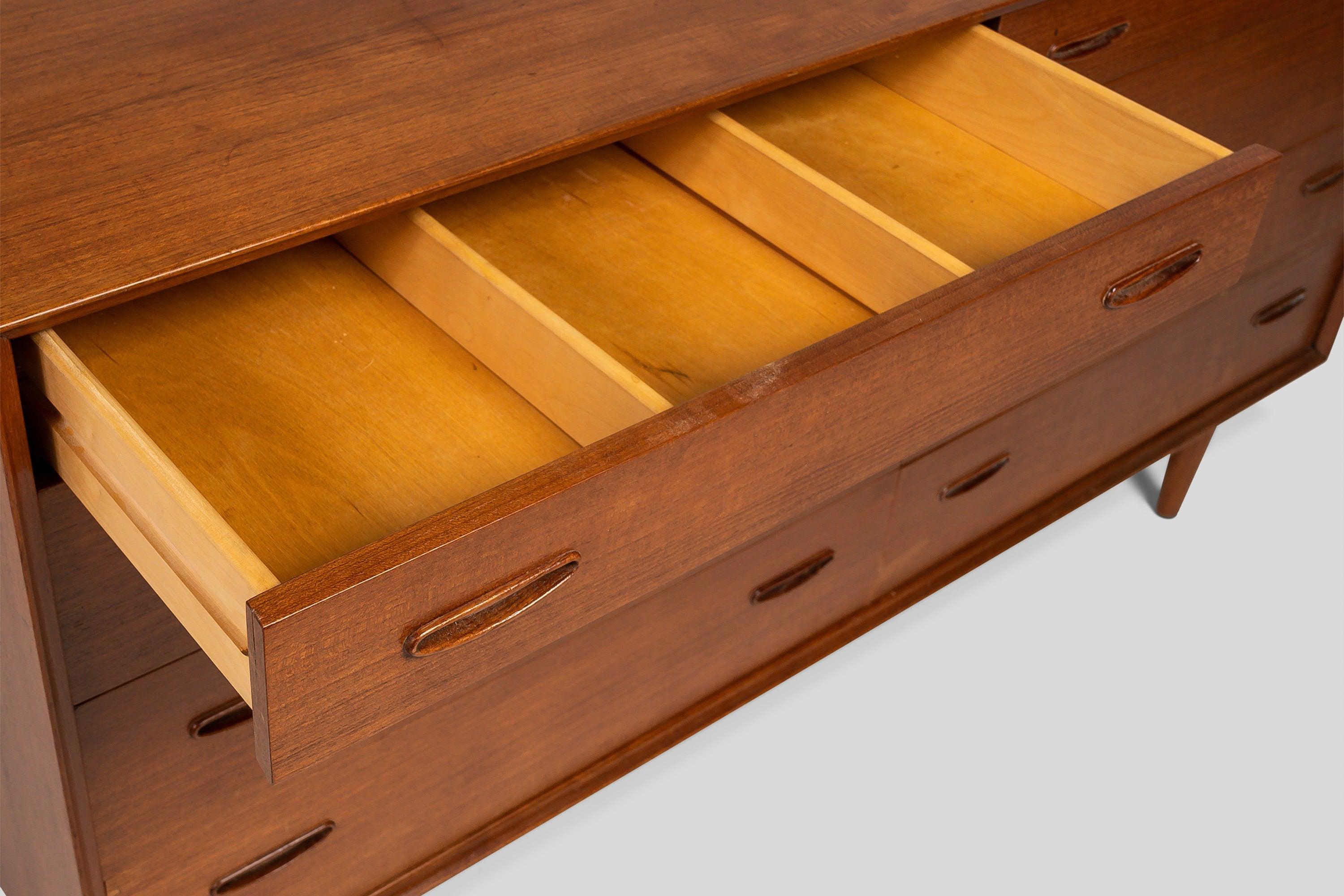 Equal parts function and elegance this exquisite eight drawer dresser, designed by the renowned Arne Vodder, is magnificent example of Danish Minimalist design. Constructed of teak with exceptional woodgrains and featuring intricate inset handles