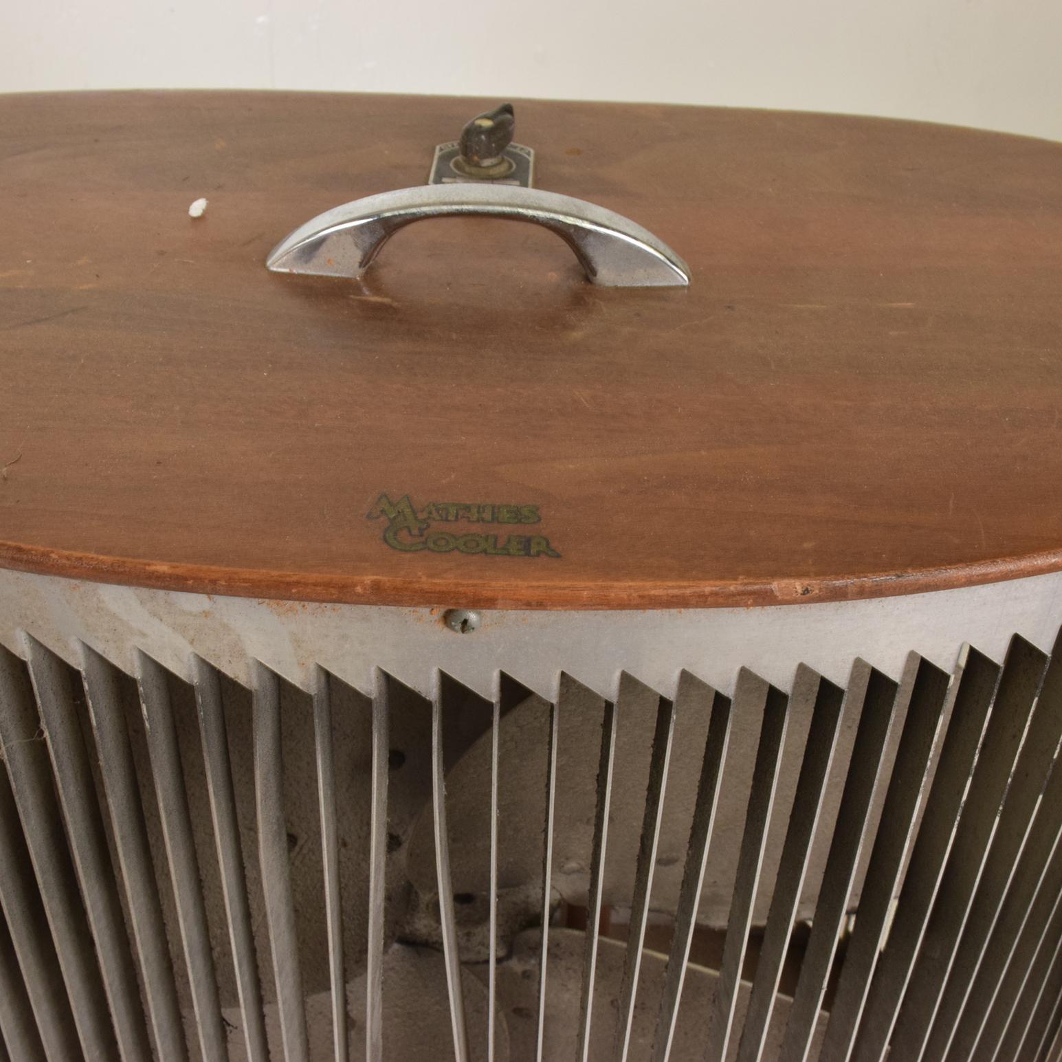For your consideration, a Mid-Century Modern electric fan Mathes cooler vintage decorative.

Made in the USA, circa 1960s. 
Walnut wood with aluminum frame.