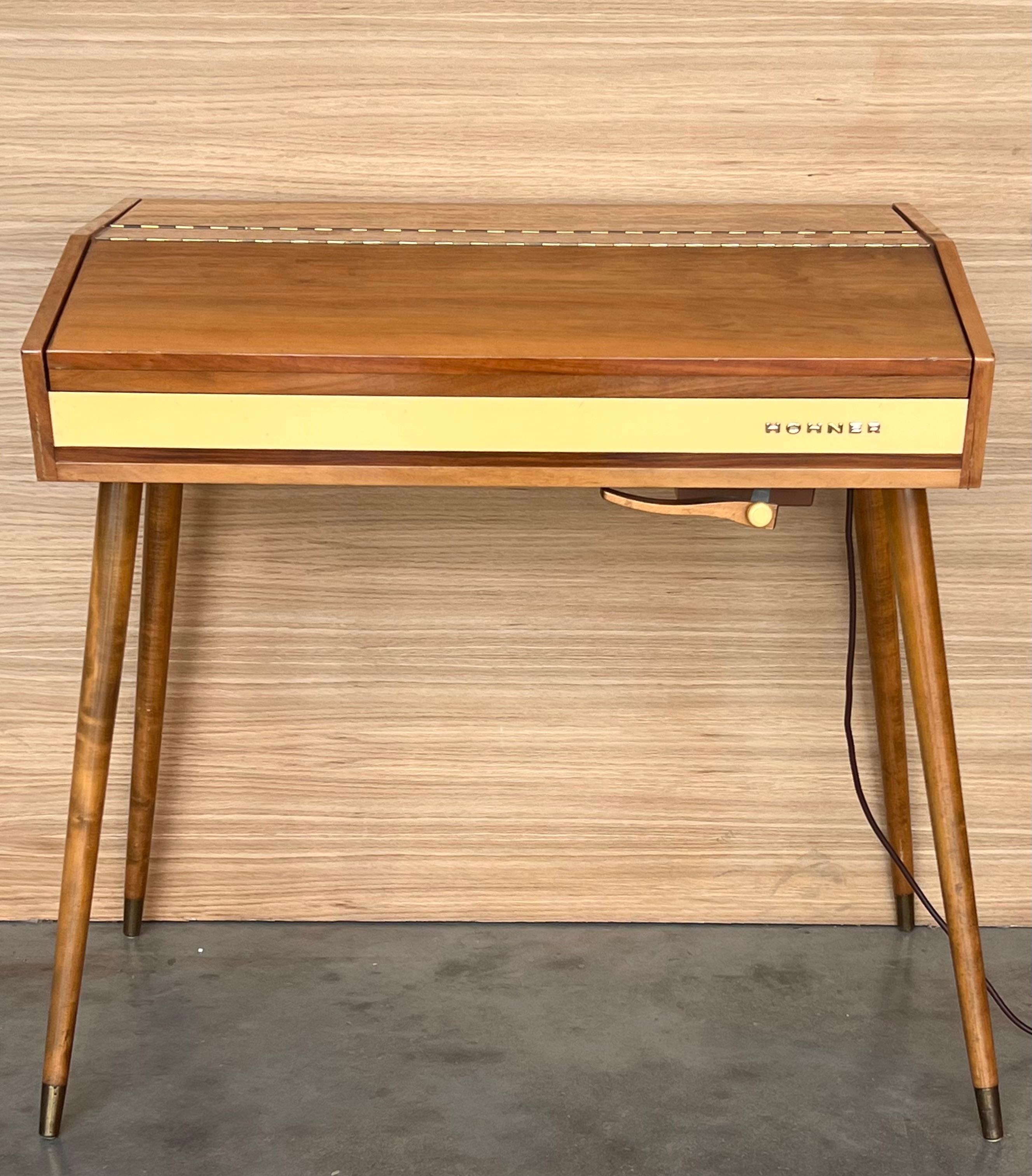 Step back in time with this masterfully-crafted Danish Mid-Century Teak Pianette . From the heart of the 1960's, a period when design and craftsmanship merged in perfect harmony, this pianette encapsulates the very essence of Scandinavian