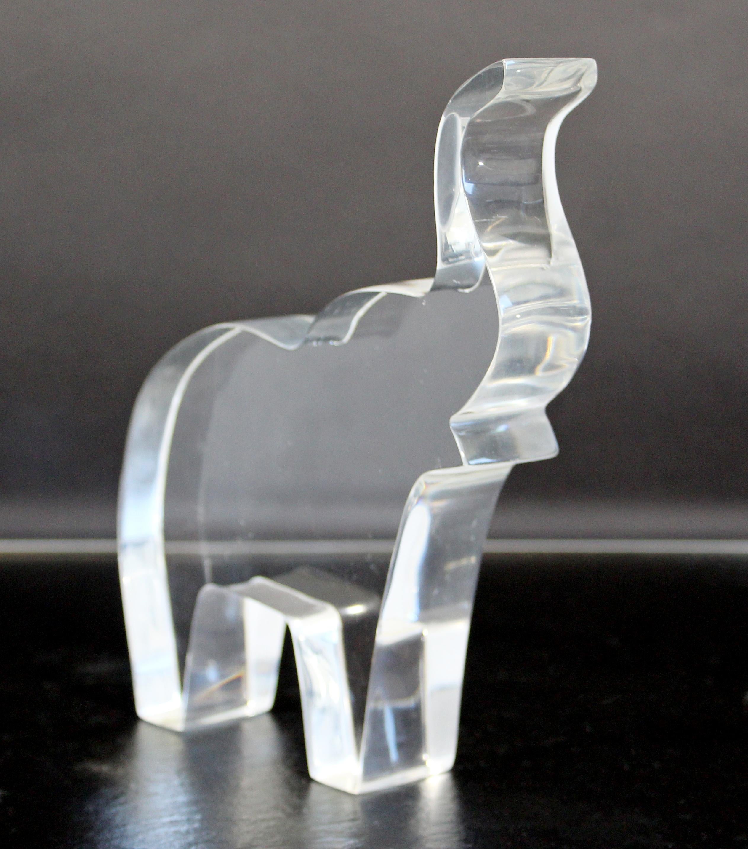 For your consideration is a sweet elephant table sculpture, made of clear Lucite, in the style of Guzzini, circa 1970s. In excellent vintage condition. The dimensions are 6