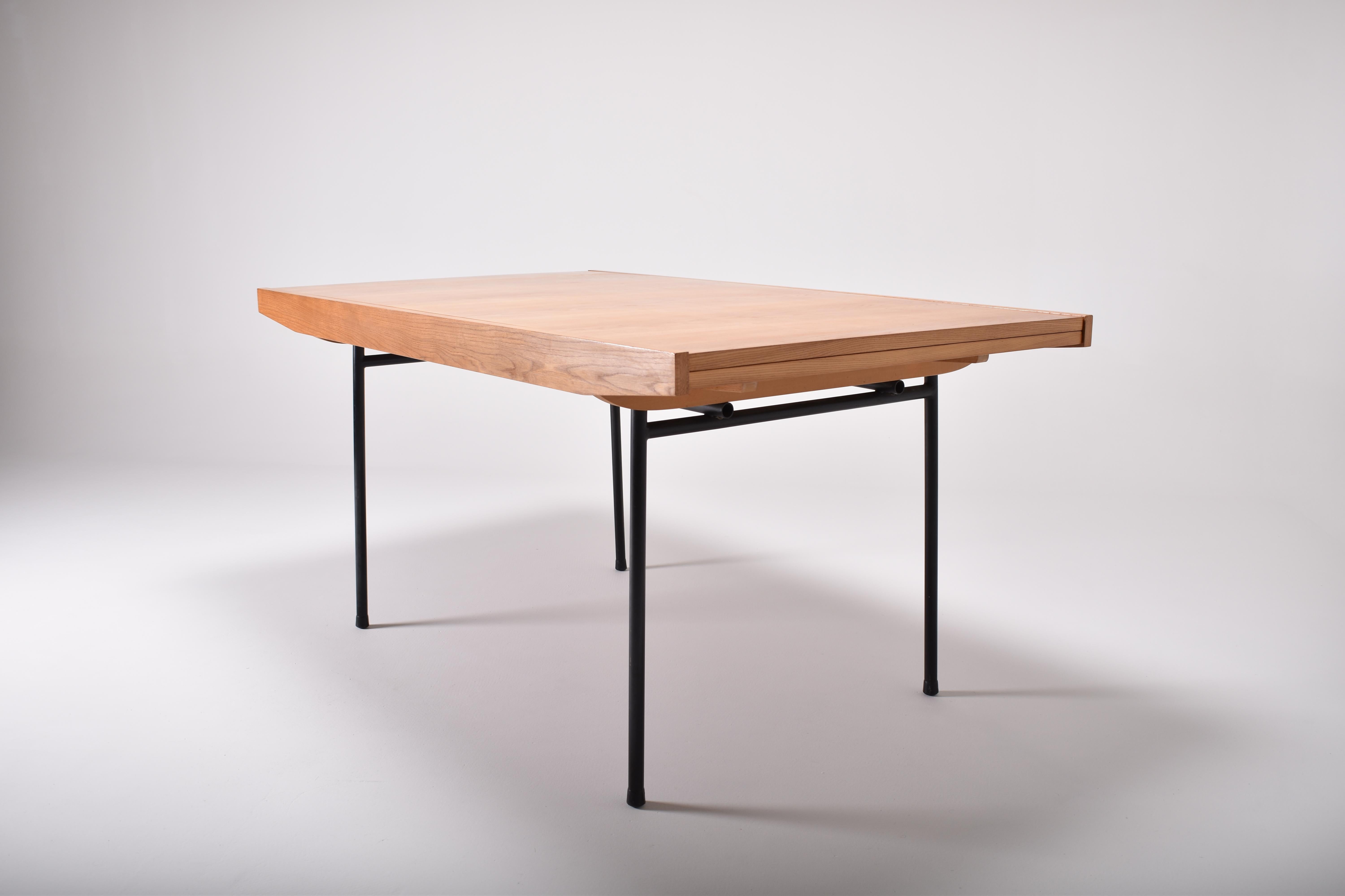 Model 324 elm dining table designed by Alain Richard and produced by Meubles TV, France in 1953.
This elegant table has two cherrywood extensions, each of 35 cm (13.8') increasing the length from 151 cm to 220 cm (60' to 87')
The elm top rests on