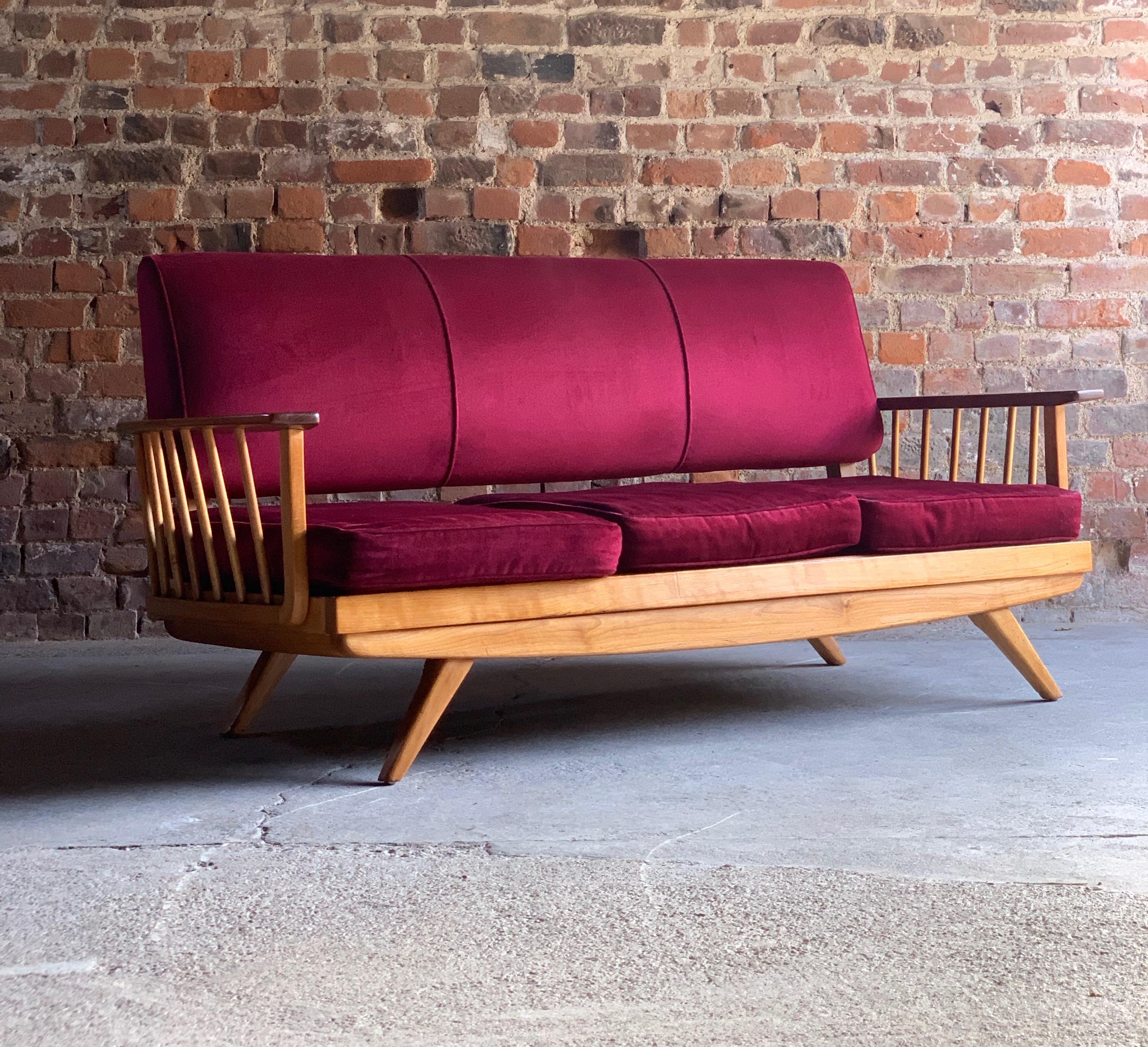 Mid-Century Modern elm sofa pair Danish, circa 1960s

Magnificent midcentury blonde elm sofa circa 1960, comprising of three seater sofa dressed in cranberry red velvet upholstery with spindle supports, raised on tapering legs, comes with matching