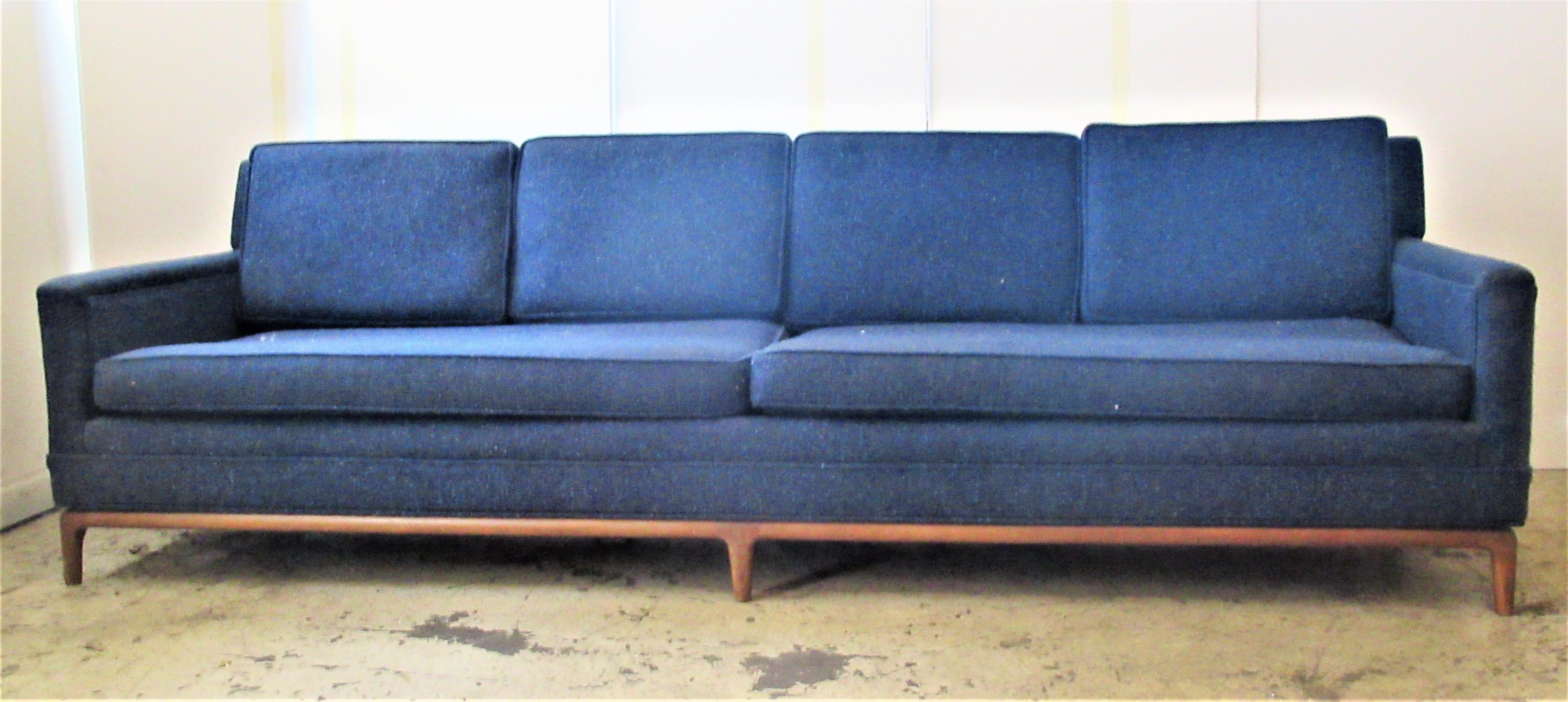 A very well built good quality all original period Mid-Century Modern eight foot elongated form sofa with lower full wraparound walnut frame having six tapered legs. Attributed to T.H. Robsjohn - Gibbings for Widdicomb. There is no label present.