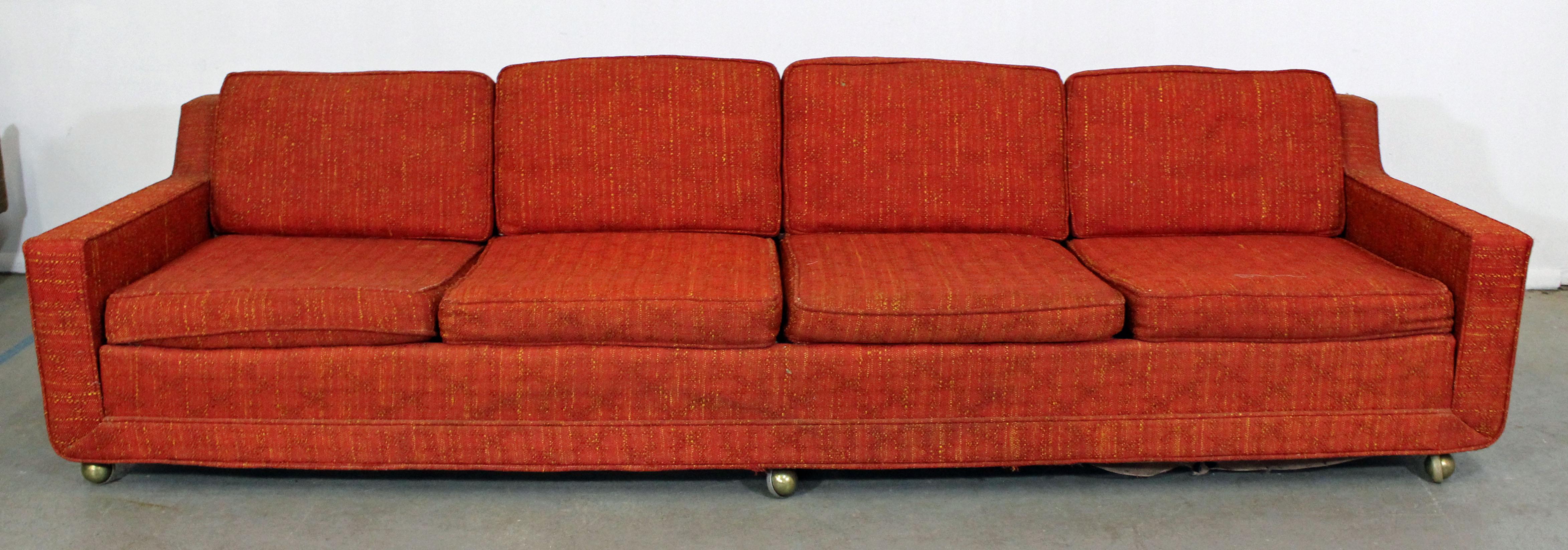 What a find. Offered is an elongated midcentury sofa with four seats by Kroehler. Features three caster wheels in front and wood legs in back, which makes for easy moving. Perfect for entertaining! It is structurally sound showing age wear. Will