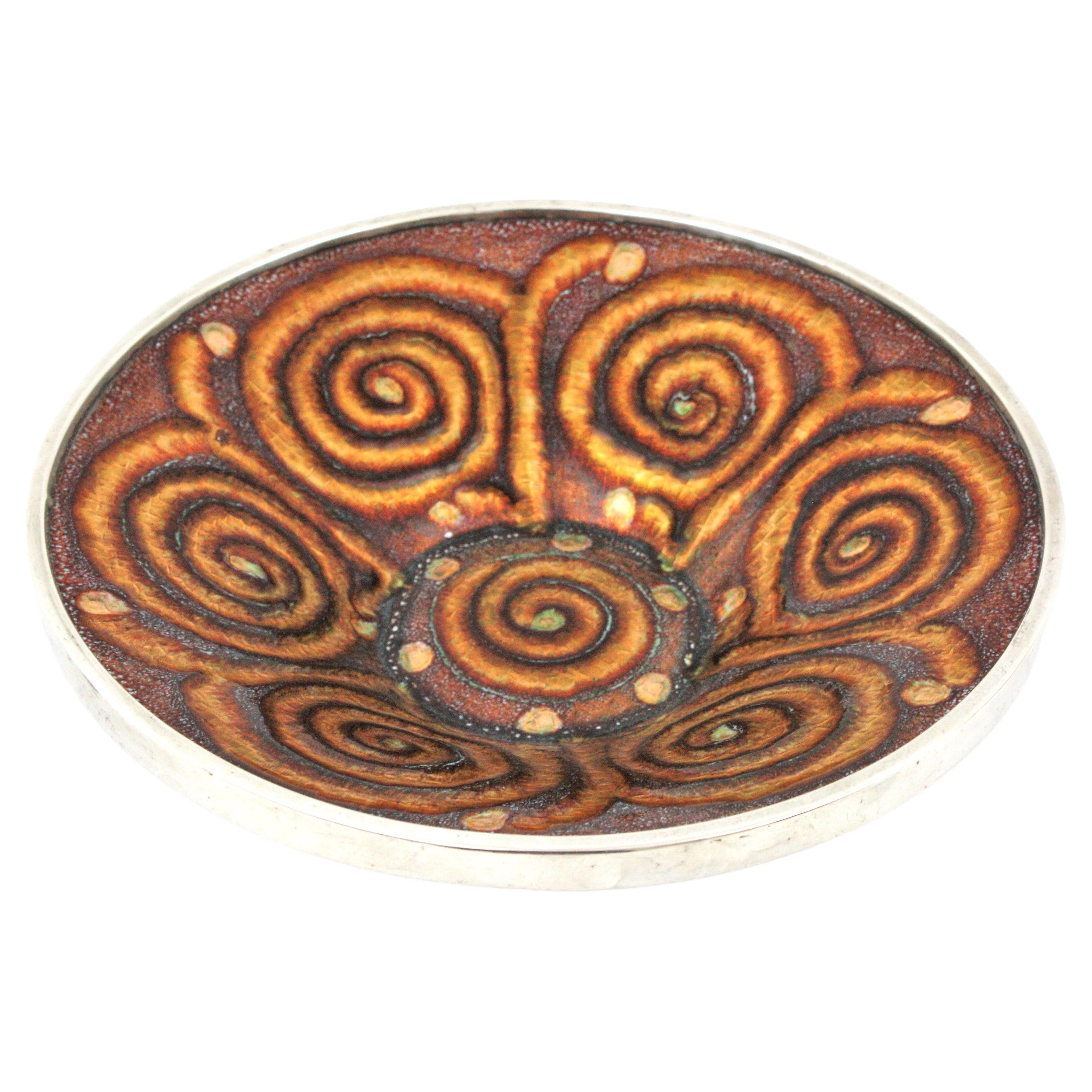 Enamel and Sterling Silver Midcentury Footed Bowl, Spain, 1950s
Exquisite enamel dish with colorful vibrant glaze made in the Mid-20th century period. 
Eye-catching design with spirals in golden, amber and brown shades and blue enamel at the back