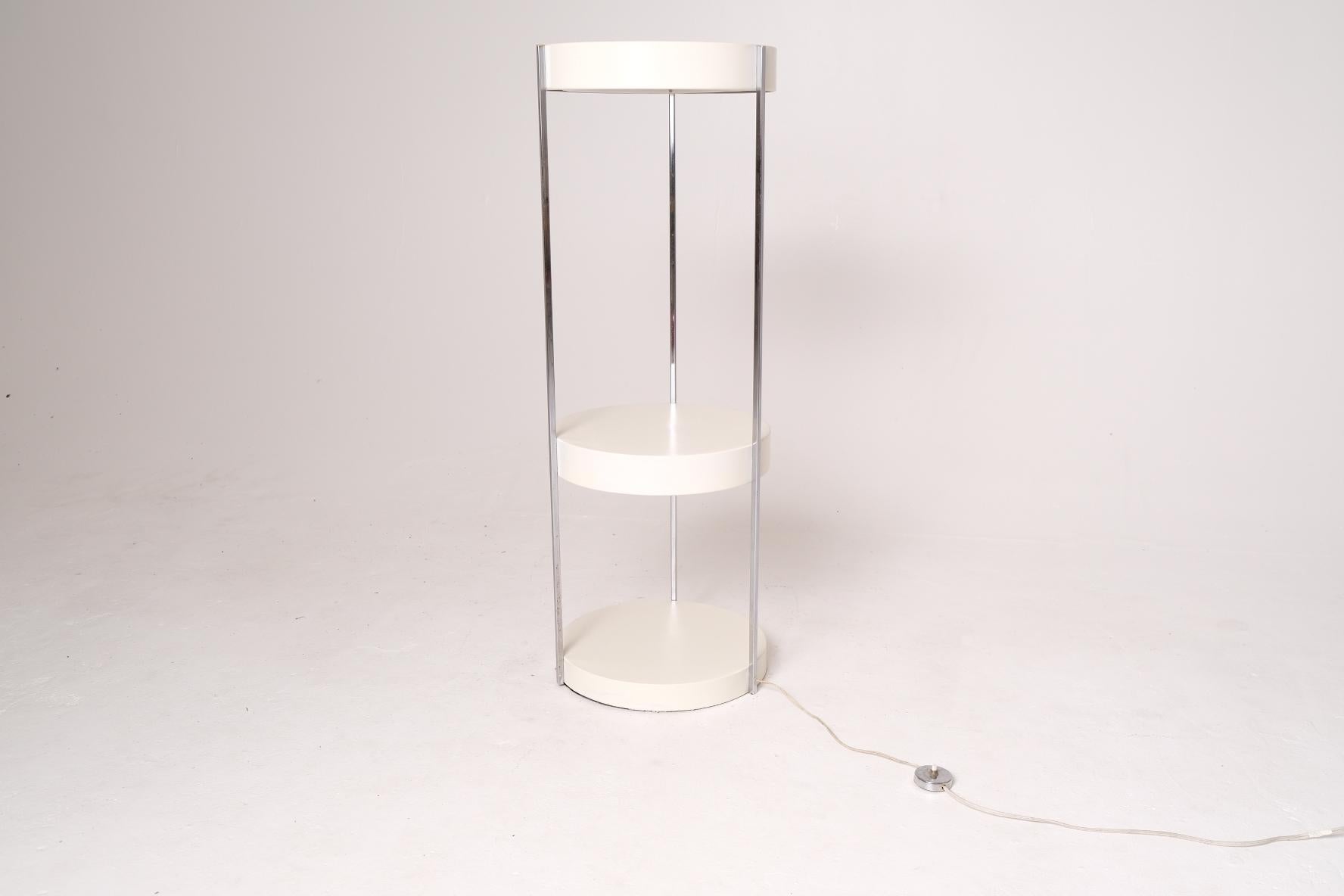 A rare and highly functional illuminated étagère floor lamp designed by George Kovacs, circa 1970s. This minimalist piece showcases Kovacs’ signature blend of utilitarian innovation and refined modernist design. Constructed with three circular
