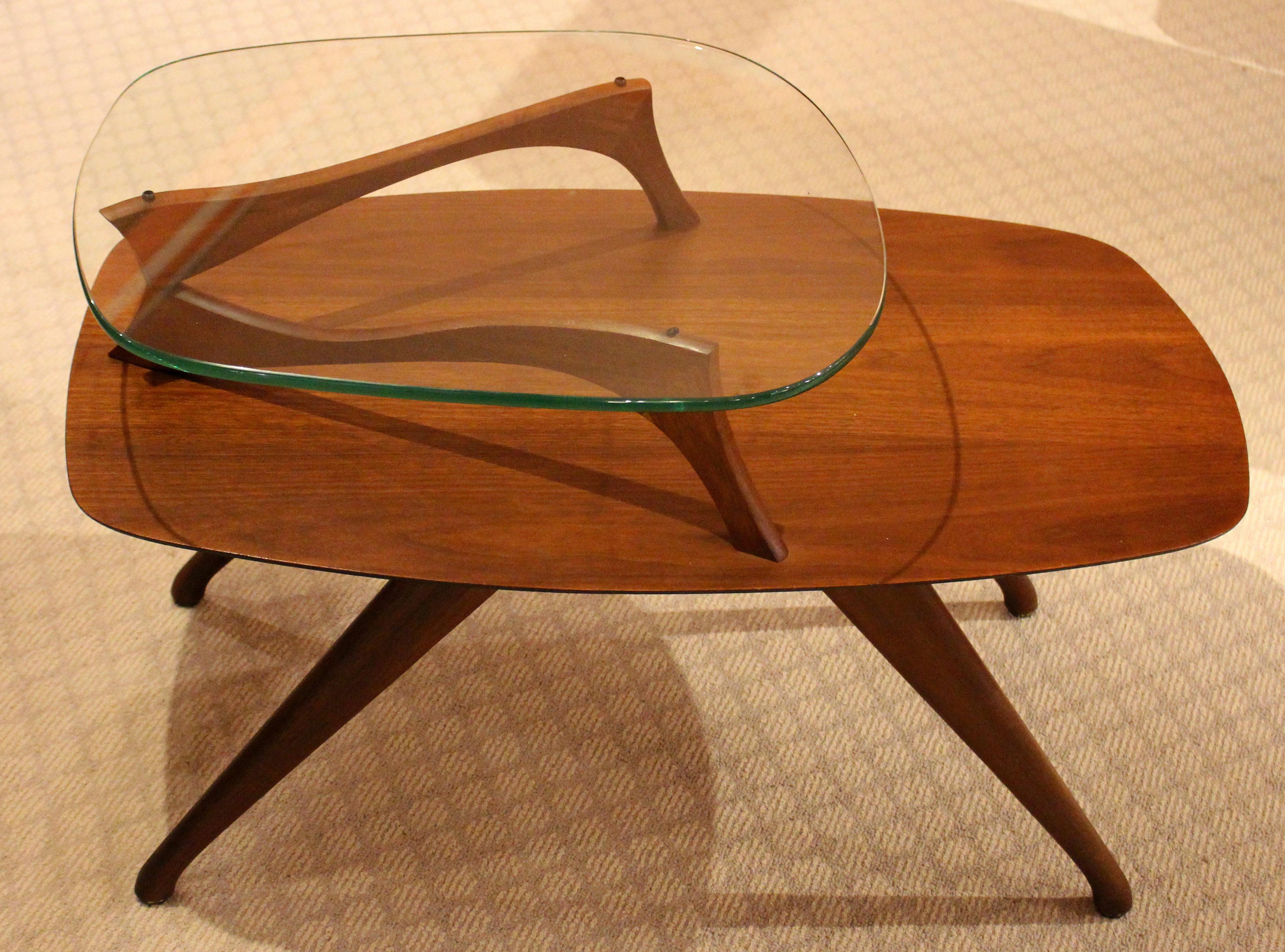 Mid-Century Modern side table or end table, walnut and glass, c.1950-60s. One of the great designs of the mid century modern era. Attributed to Vladimir Kagan. This table came out of a NJ home where it was with a Kagan guitar pick table. Possibly