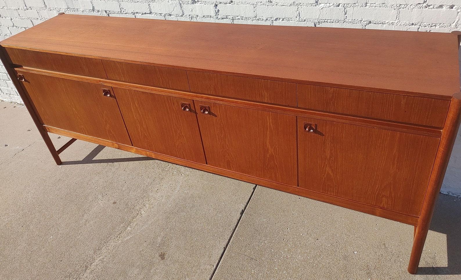 Mid Century Modern English Modern Teak Credenza by McIntosh

Above average vintage condition and structurally sound. Has some expected slight finish wear and scratching. Top has been refinished and does not have original factory finish. Finished