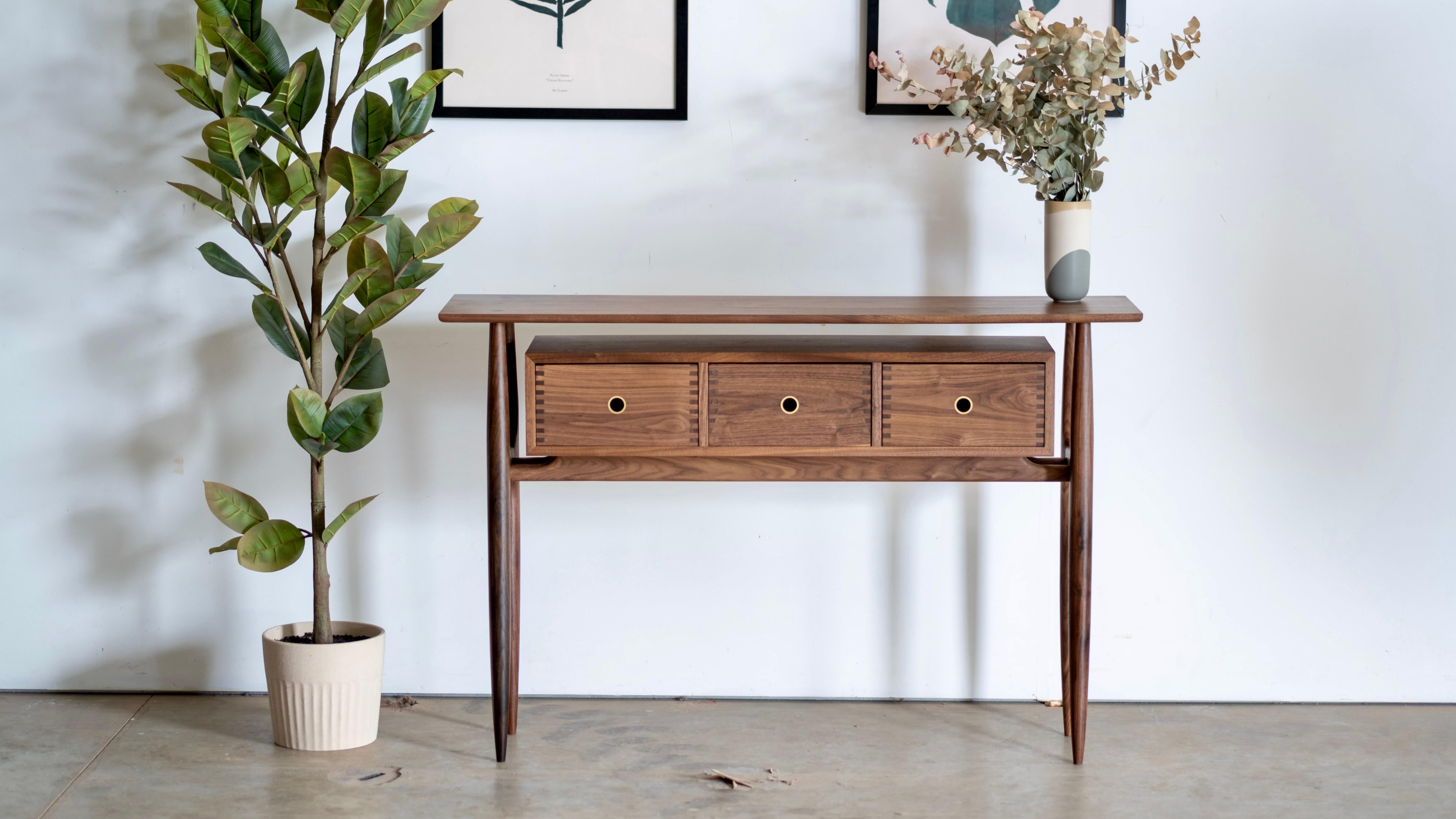 Entry table with subtle soul. This table is built with all hand turned parts and wedged exposed tenons. The floating box features rounded dovetails and the edges are all organically pillow shaped by hand. If you appreciate the function and charm of