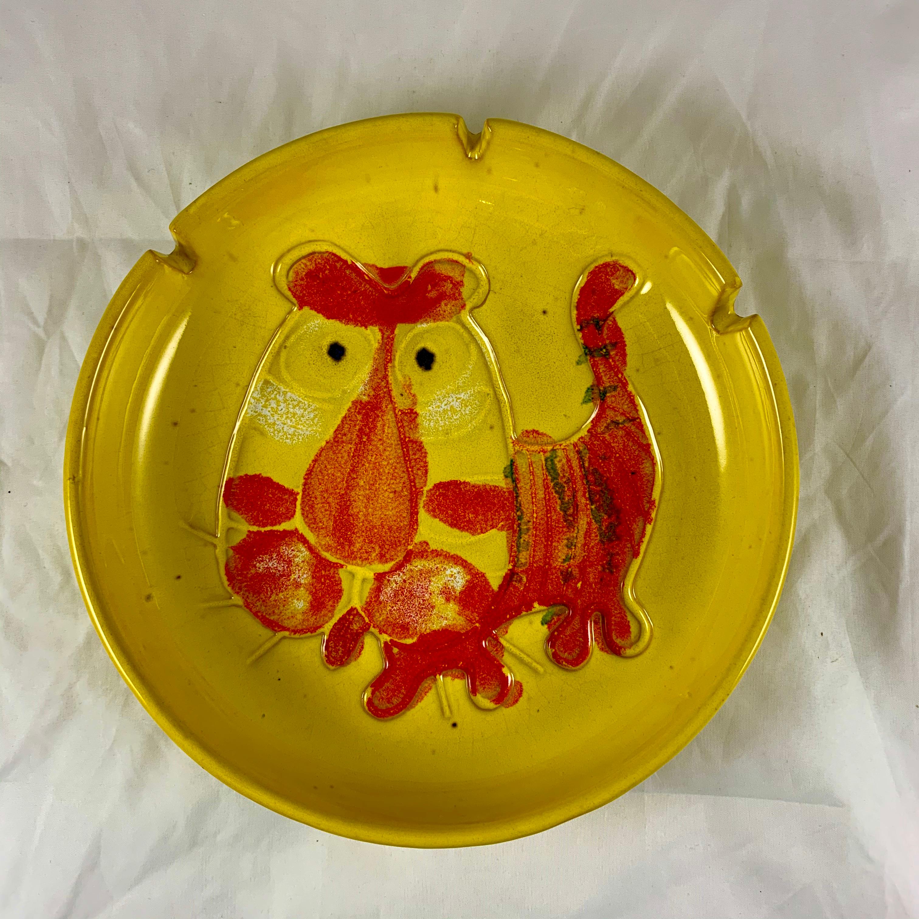 An oversized midcentury Tiger ashtray, signed B. Walsh (Bennett Walsh), dated 1973.

Made of stoneware and showing an incised image of a tiger glazed in primary pop-colors of orange on yellow. The deep rim has three slots for holding cigarettes. A