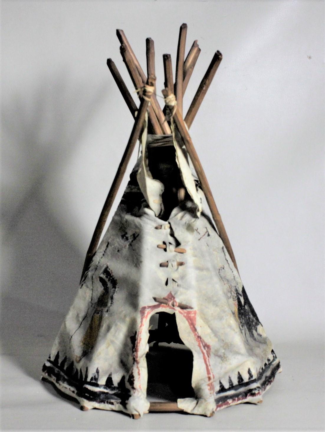 This Mid-Century Modern era Indigenous American miniature teepee is unmarked, but presumed to have been made in Canada in approximately 1945. This teepee was most likely made as a Souvenir or toy for tourists and sold at a 'Trading Post' which were