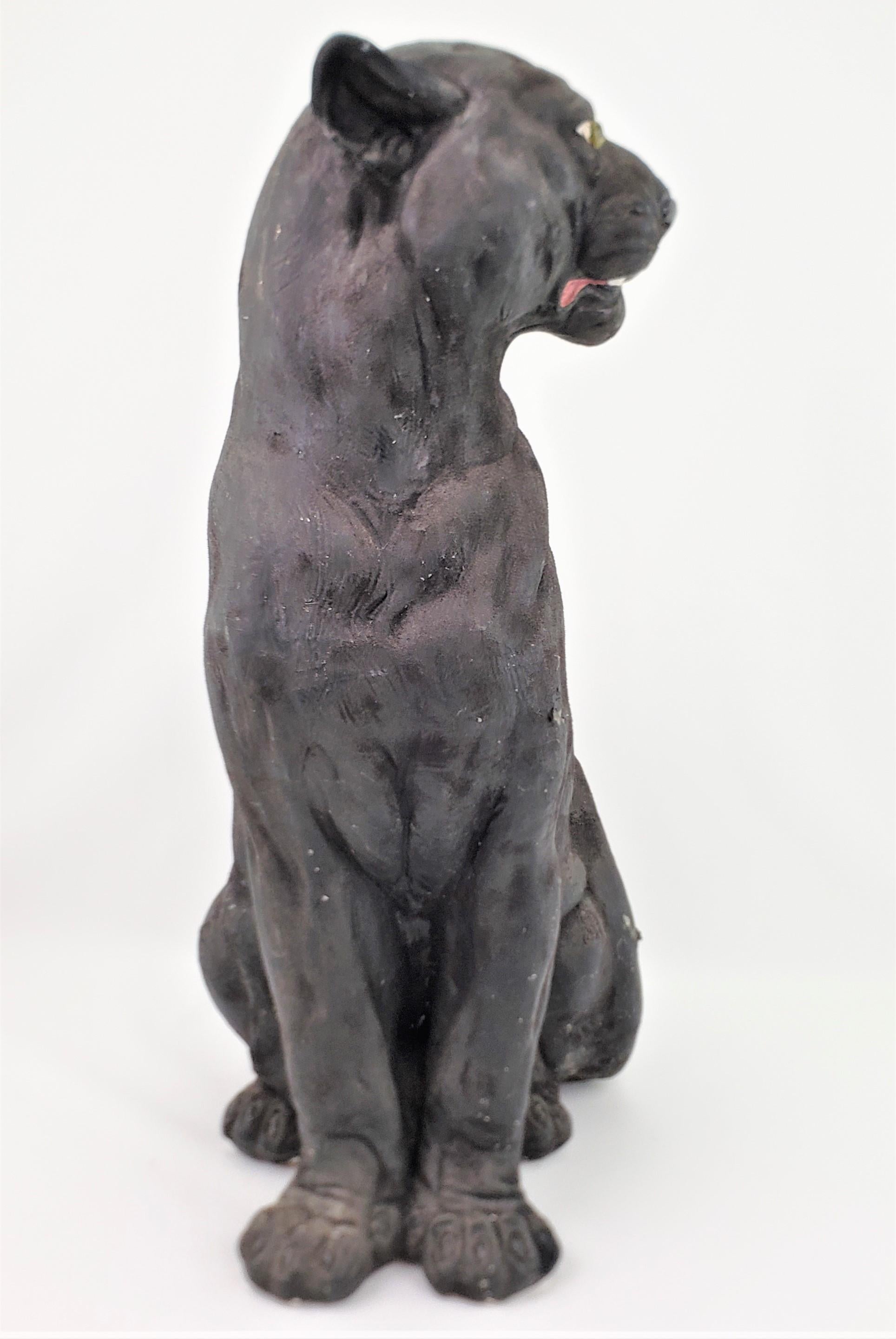 This large and substantial cast plaster sculpture is unsigned, but presumed to have been made in the United States in approximately 1960 in the period style. This large sculpture depicts a seated black panther and has been cold painted with a