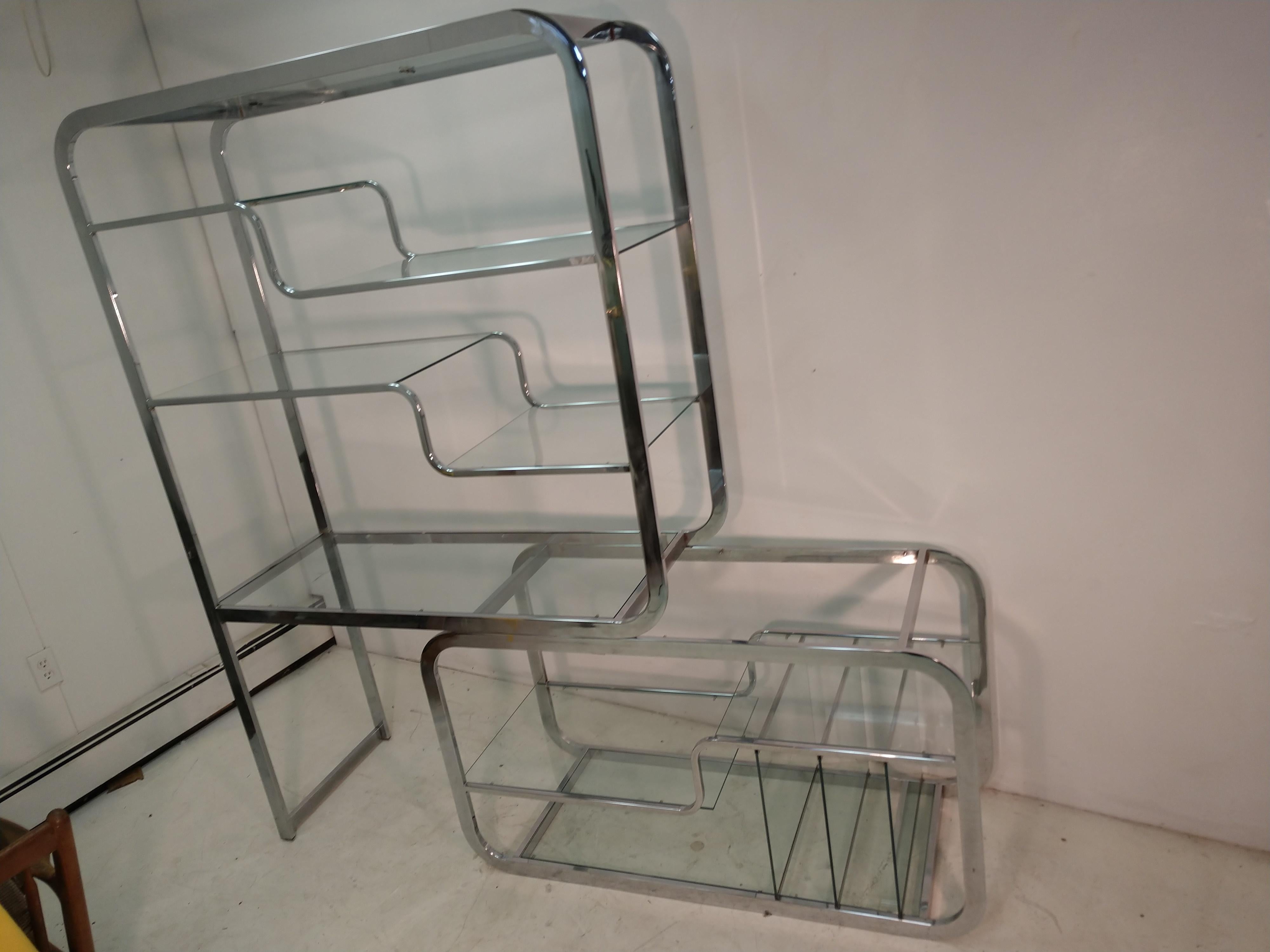 Fabulous 2 part chrome and glass Etagere, room divider and cocktail table.
Versatile shelf unit which opens out to stretch it's possibilities.
Lots of storage, even for record albums. Created by Design Institute of America. Stretches out to a max