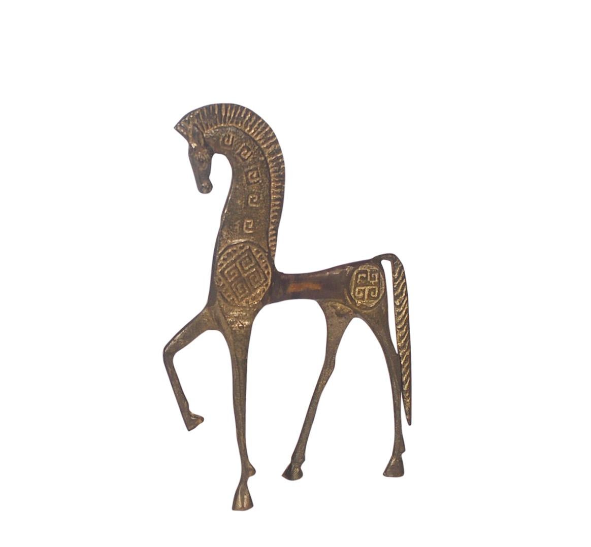 A lovely brass Etruscan horse figurine in the style of Frederic Weinberg. It features a cast brass form with Etruscan print design.