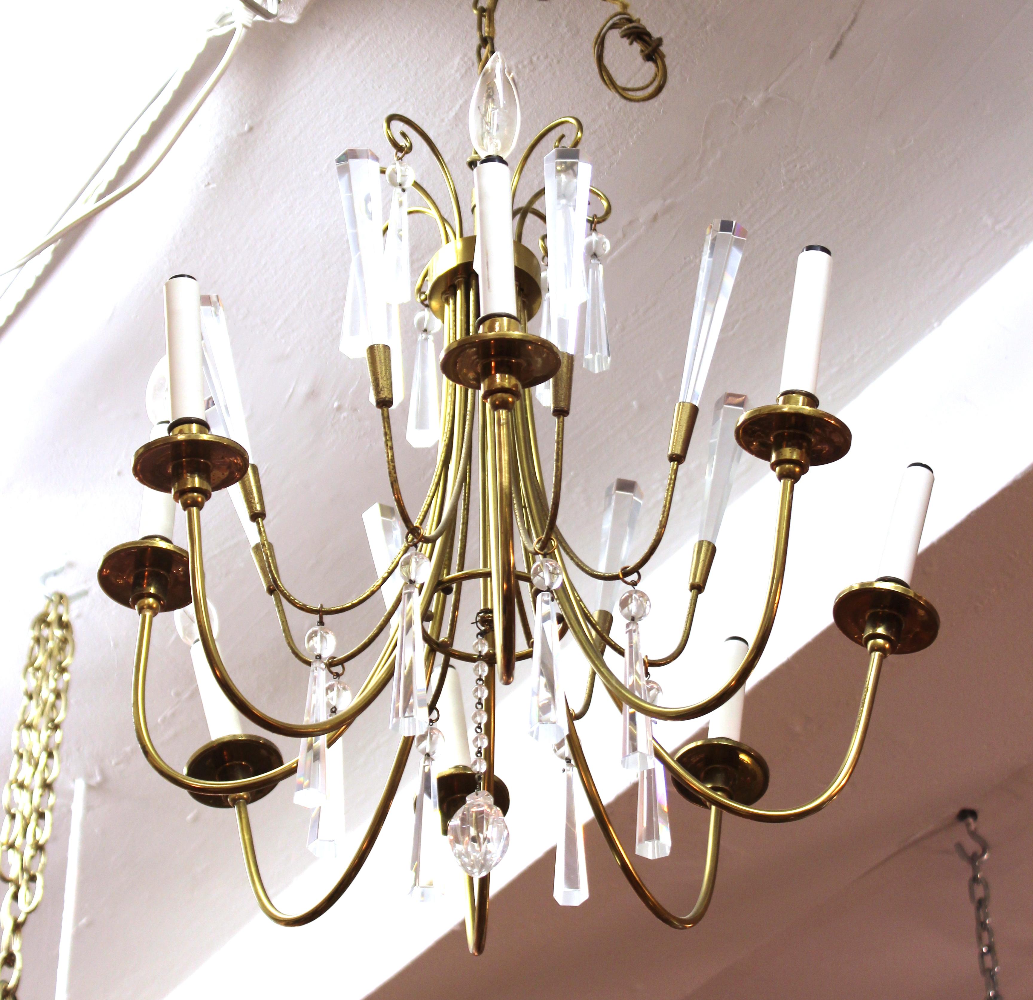 Mid-Century Modern European brass chandelier with crystal pendants. The piece was likely made in Austria. In great vintage condition with age-appropriate wear and use.