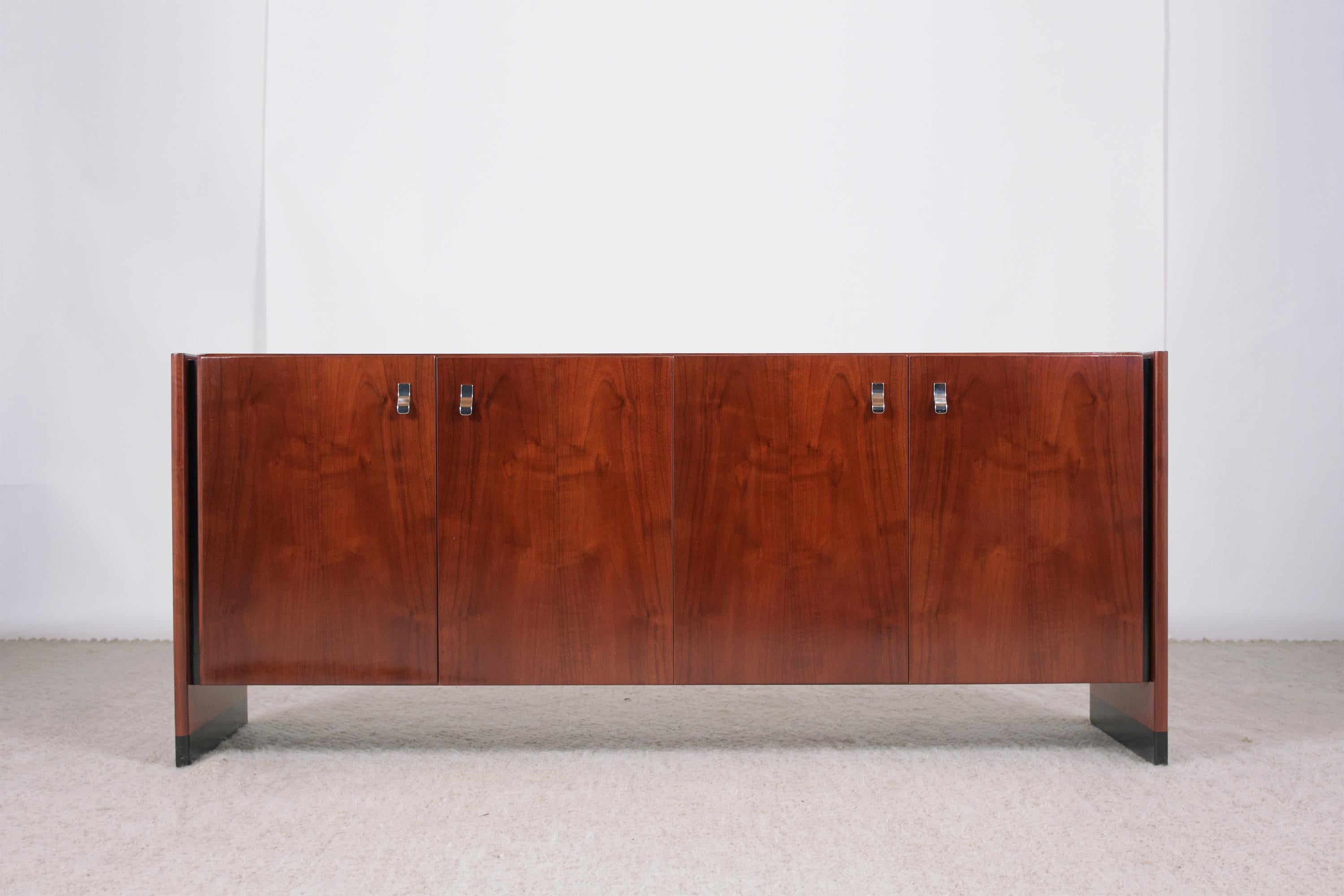 Step into the world of mid-century luxury with our 1960s Mid-Century Modern Lacquered Credenza, a masterpiece of craftsmanship and style. Expertly hand-crafted from high-quality mahogany, this credenza is in great condition and has undergone