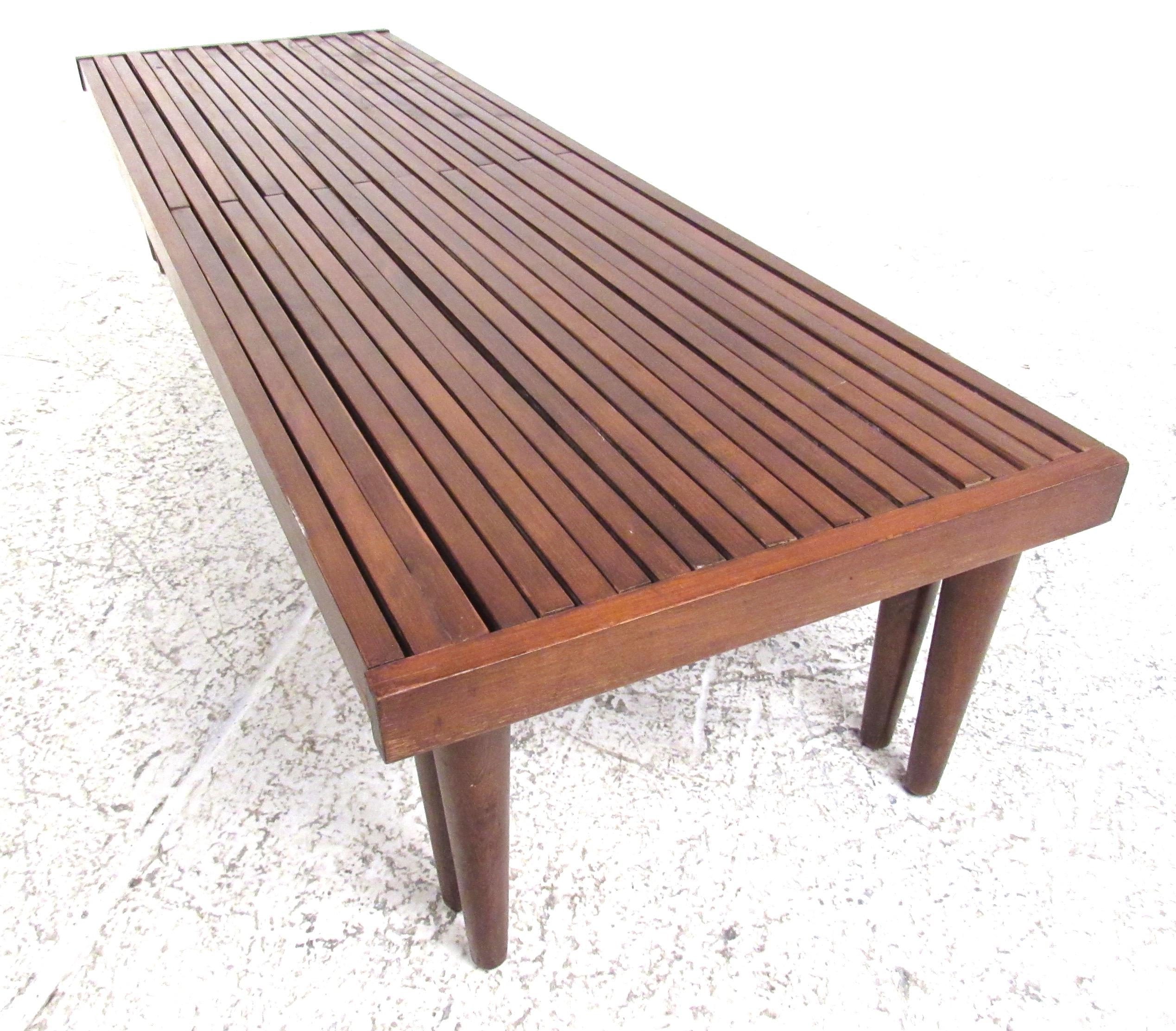 Expandable Mid-Century Modern slat bench in mahogany by Brown-Saltman. Well constructed with vintage finish, this can be used as a bench, coffee table, or a plant stand. It expands from 56