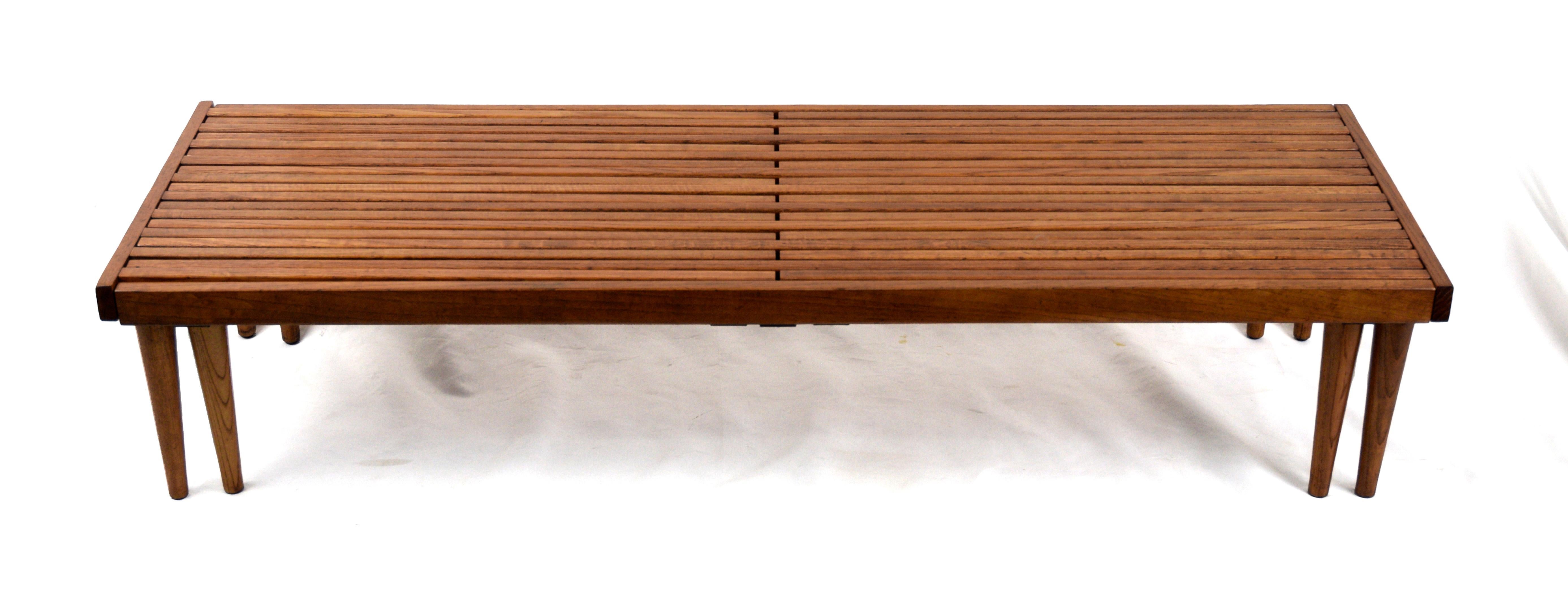 Schöne und vielseitig erweiterbare minimalistische Lattenbank aus Walnussholz aus der Mitte des Jahrhunderts, entworfen von John Keal für Brown Saltman, um 1960. Dieses moderne kalifornische Möbelstück verfügt über eine erweiterbare Schiebeplatte