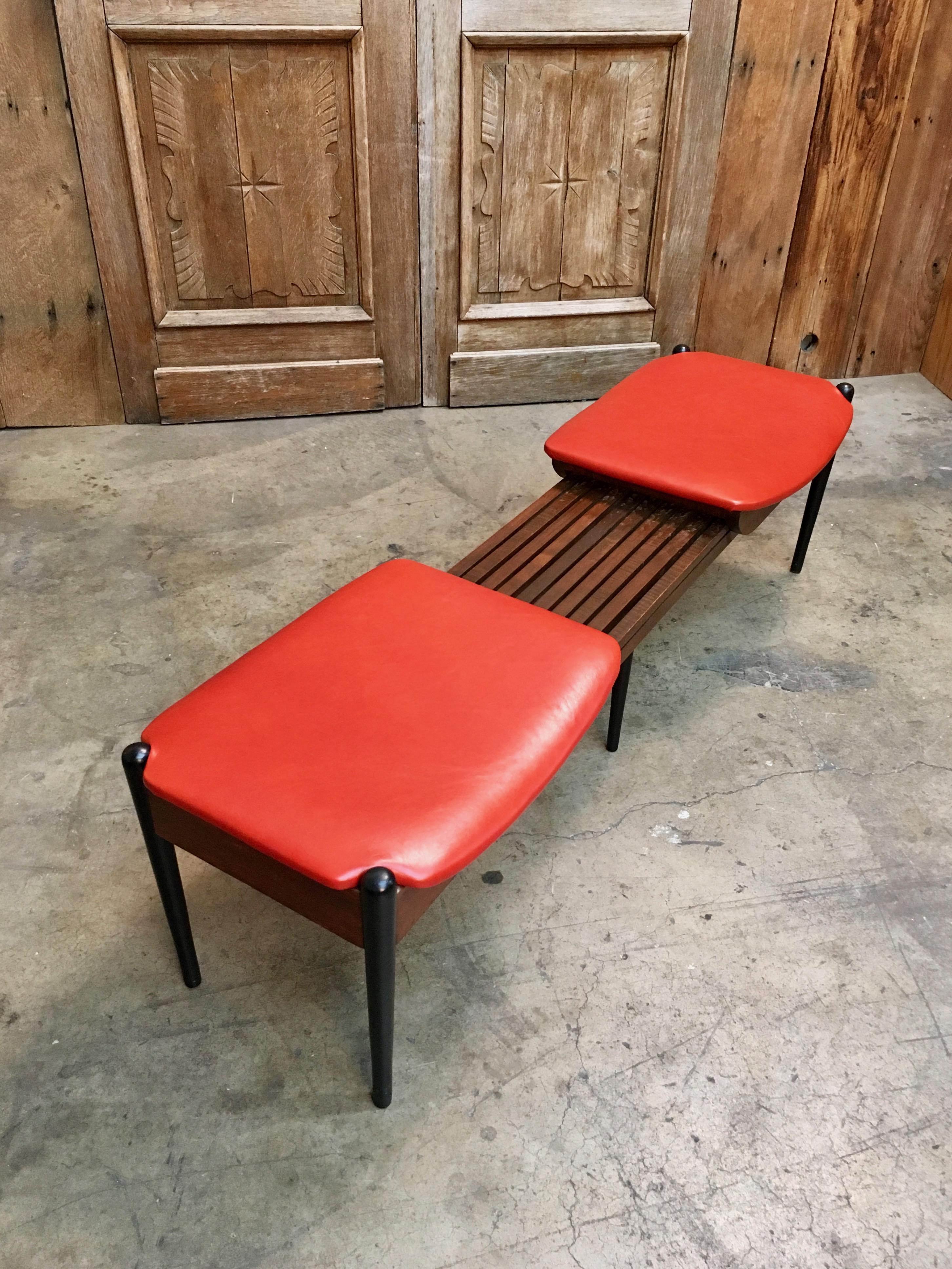 Orange leather upholstery on top of this retractable slat bench
42