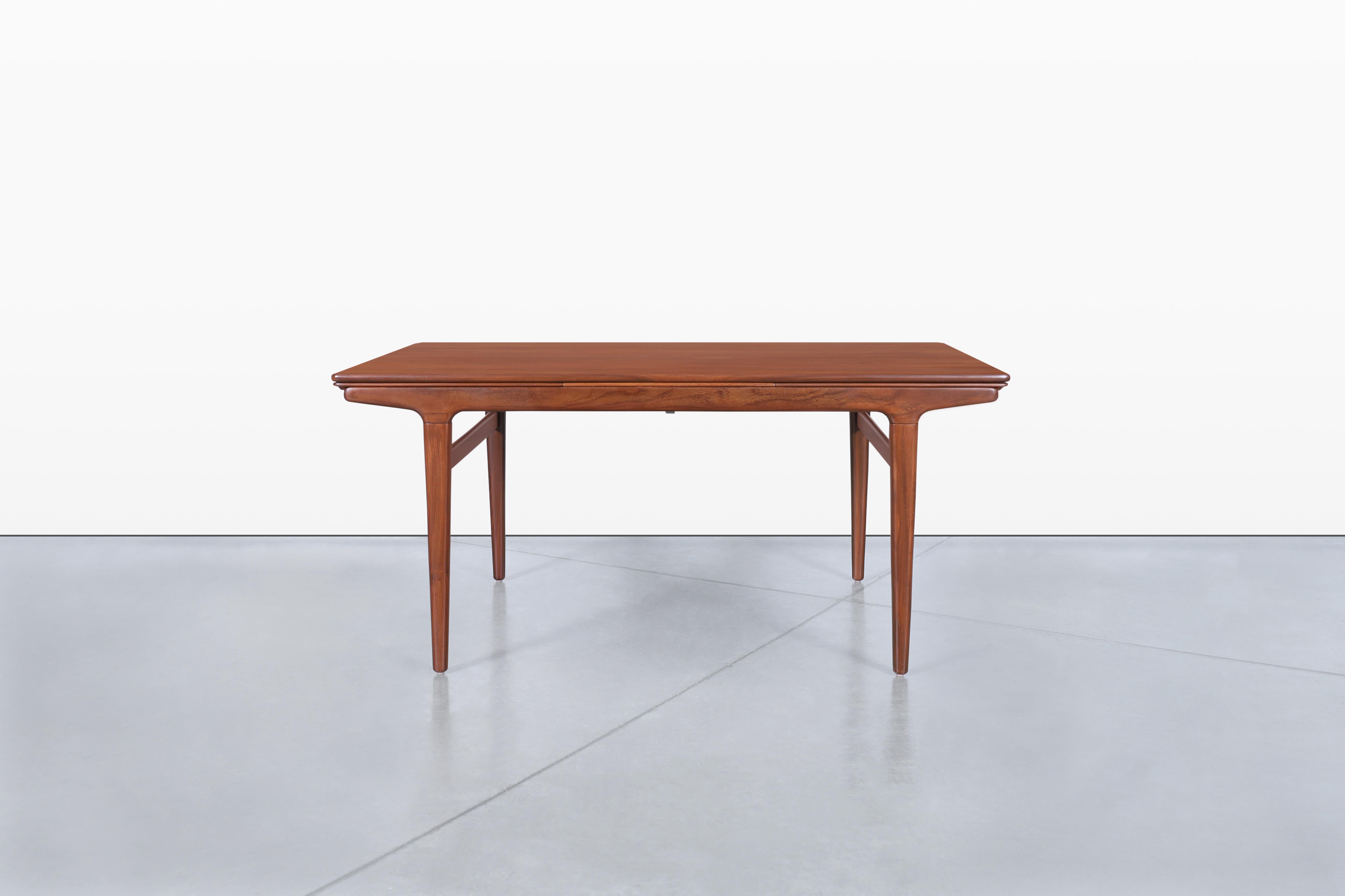 Introducing a stunning Danish modern teak dining table, designed by the renowned Johannes Andersen for Uldum Mobelfabrik in Denmark, dating back to the 1960s. This exquisite piece is both functional and stylish, making it a perfect centerpiece for