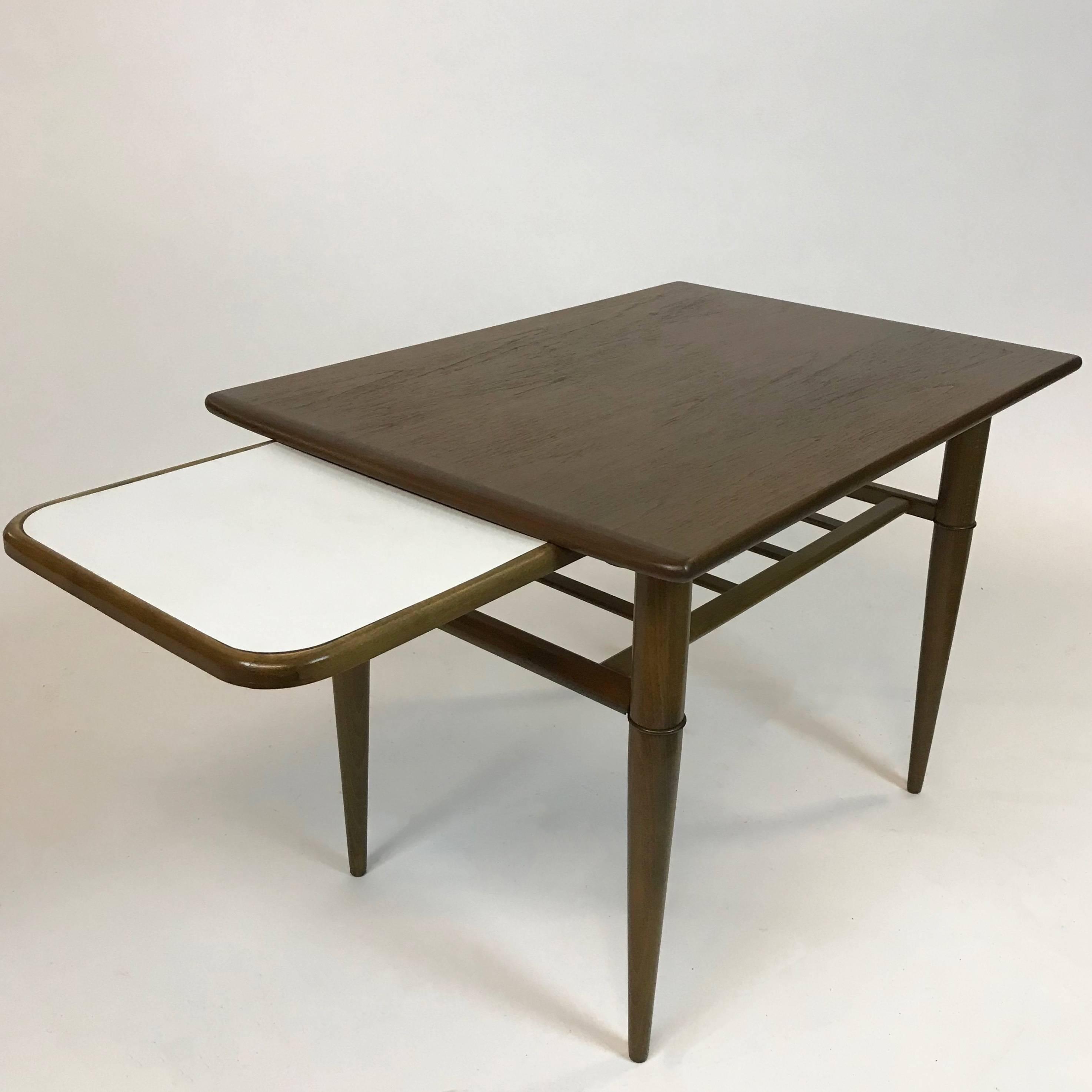 Nicely detailed, Mid-Century Modern, walnut, side table features a lower latticed tier and laminated pull-out shelf that measures 9.5 inches deep x 12.75 inches wide.