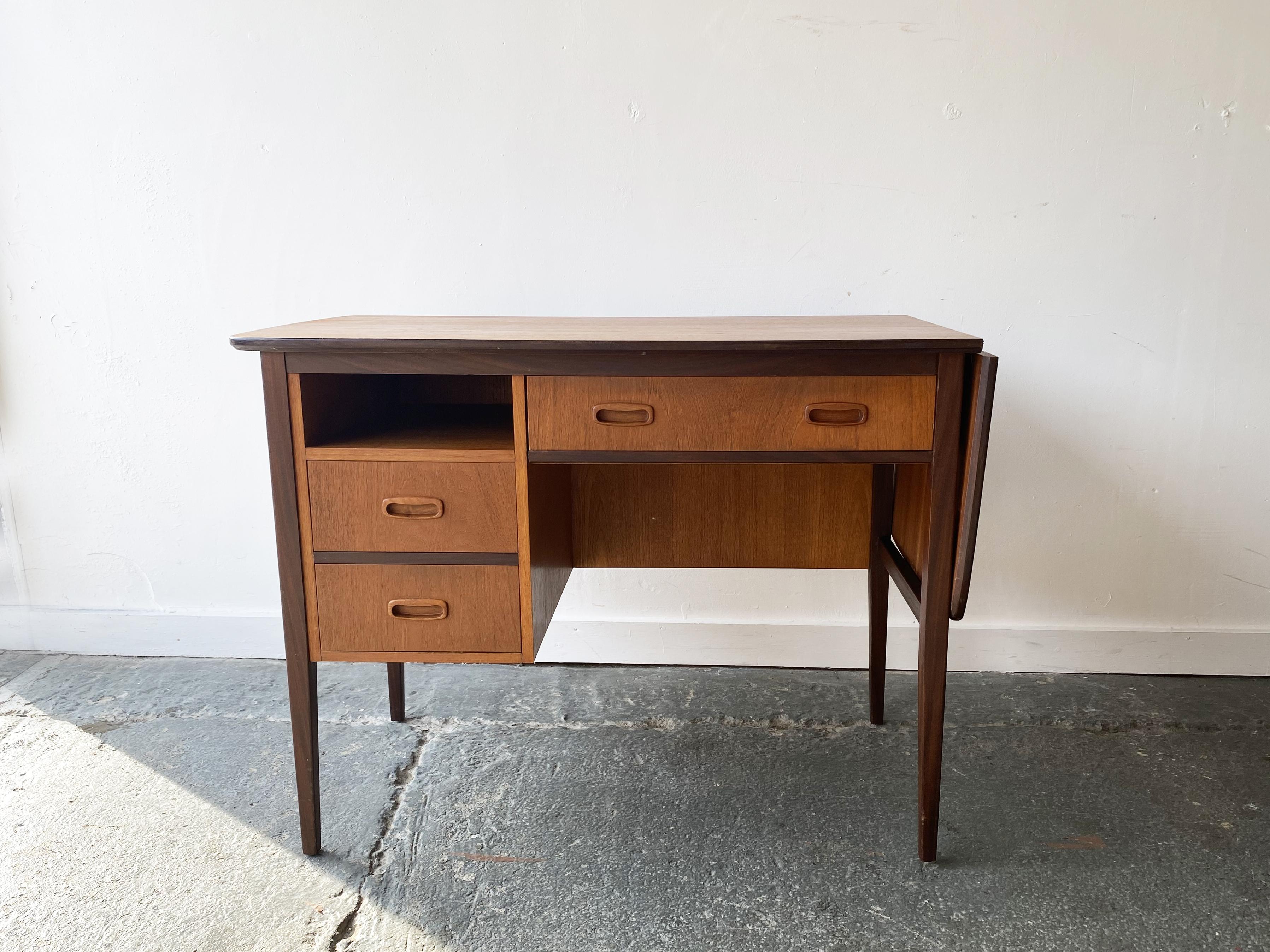 This Mid-Century desk with sliding extendable top was produced in the 1960’s by English manufacturer Uniflex. Its compact size is Ideal for smaller spaces. Also if the top needs to be shorter, it slides across allowing the hinged right hand section