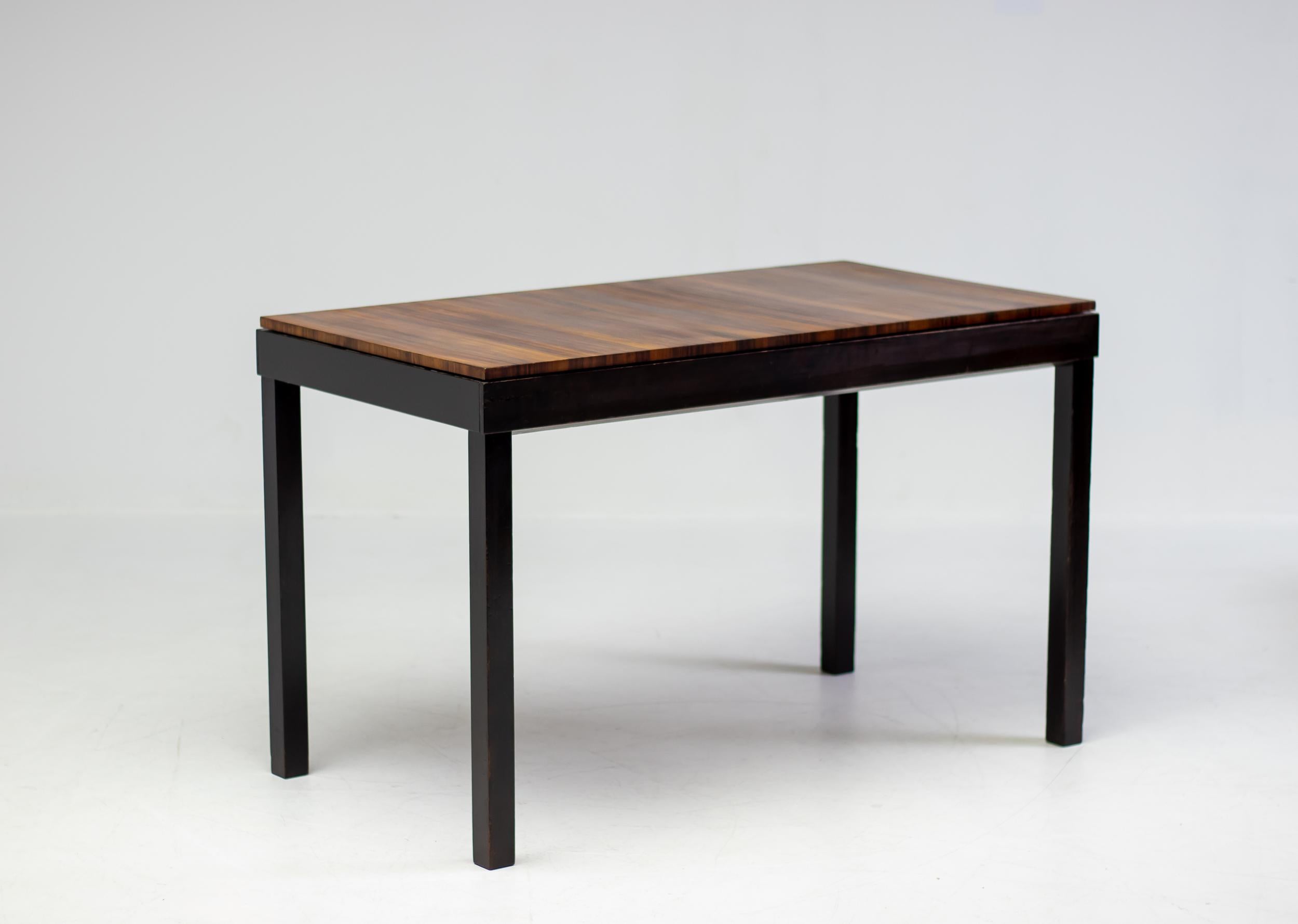 This beautiful Scandinavian Modern extendable dining table or writing desk is designed by Axel Einar Hjorth for NK in the 1930s.  The base and extension leaves are lacquered in a wonderful very dark brown chocolate color, the top is veneered in book