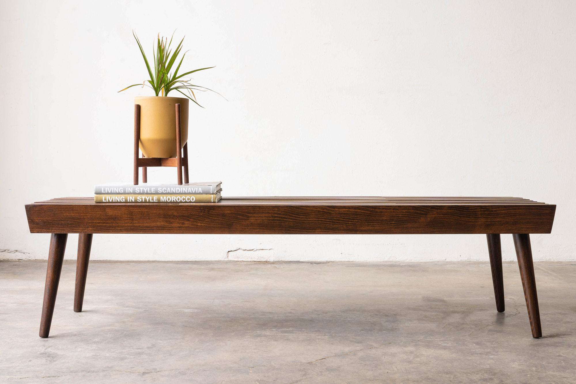 Introducing this stunning Mid-Century Modern bench, inspired by the iconic George Nelson! With its sleek design, adjustable slats, and tapered legs, this bench is not only functional but also a work of art. The unique intertwined design allows for