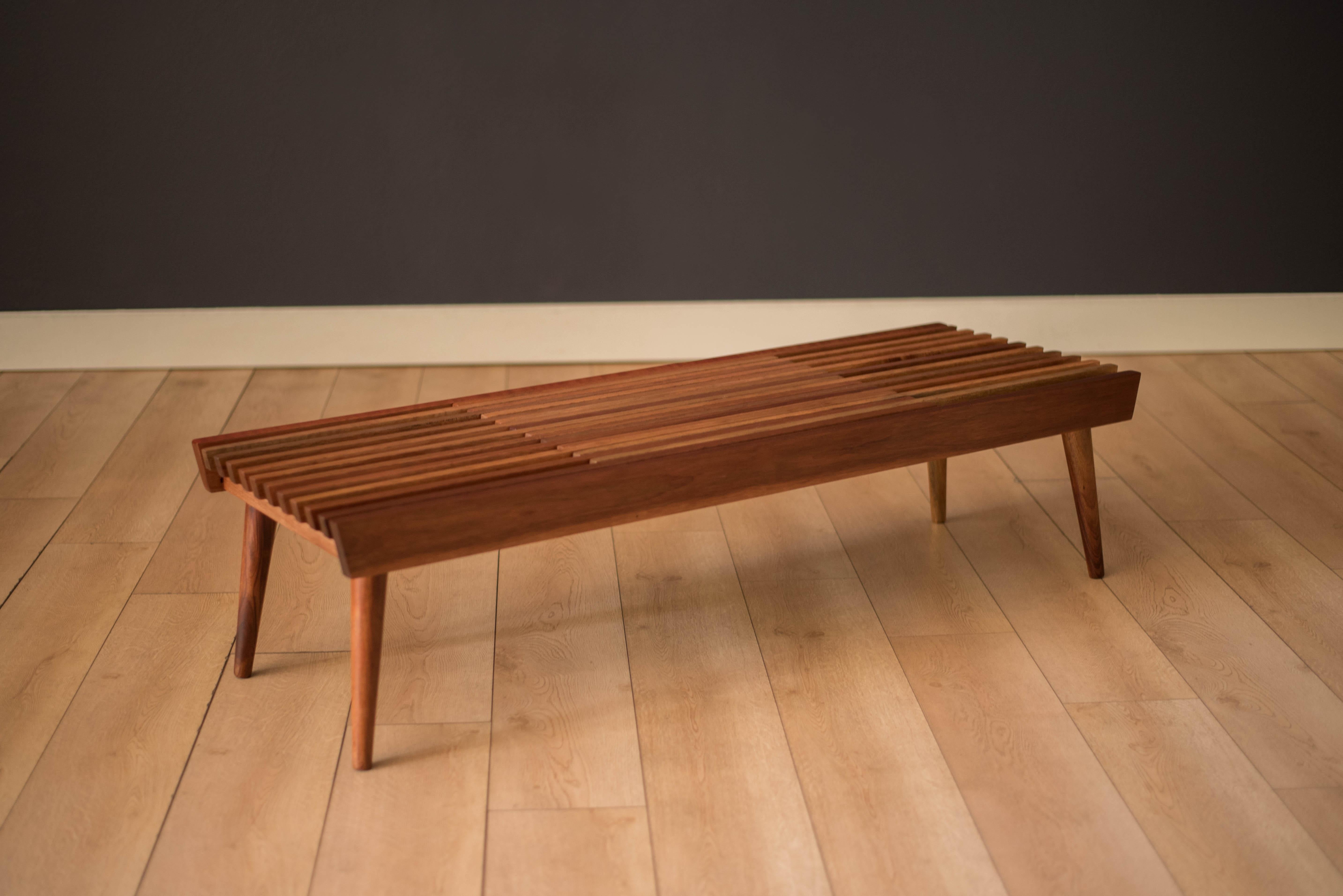 Vintage minimalist slat wood coffee table bench, circa 1960's. This versatile piece is a mid-century modern classic that features an expandable sliding top. Perfect to use as a living room coffee table, entryway or bedroom seating bench.