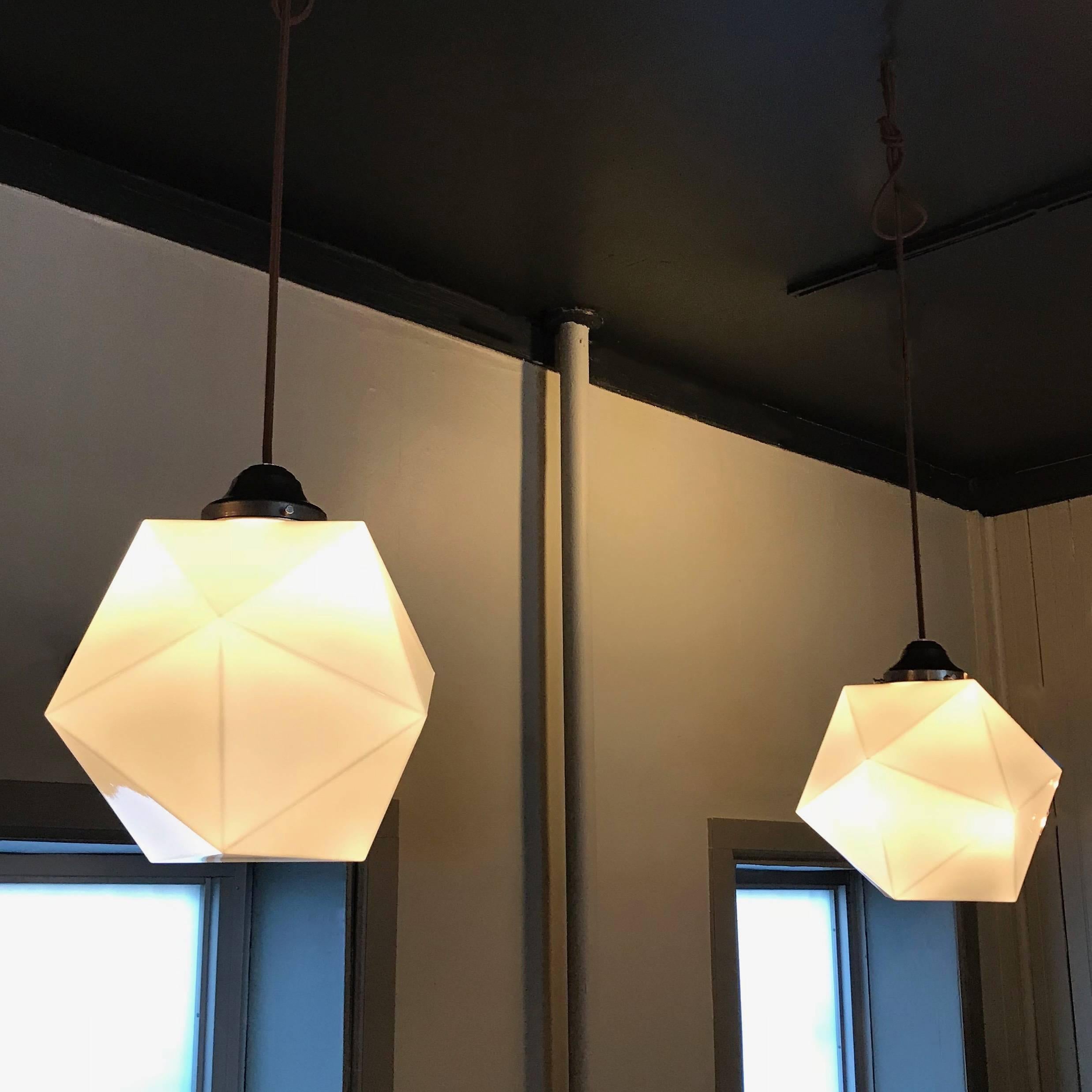 Spectacular, Mid-Century Modern, 20 sided polygon, faceted milk glass, geometric form, pendant light with brass fitter is newly wired with 40 inches of brown cloth cord. 
 