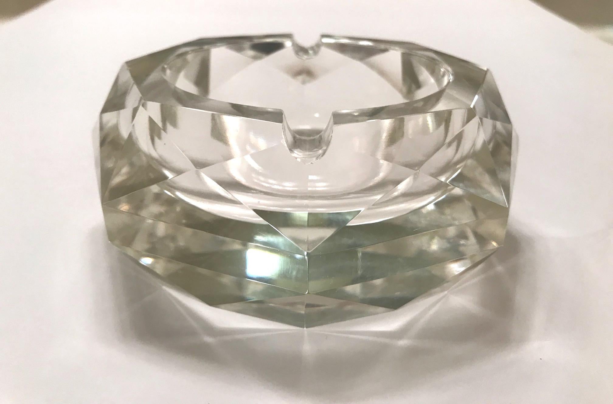 Stunning clear Murano glass ashtray with octagon form and spectacular faceted design, creating prisms of light. Shines like a diamond and is heavy in weight. Fitted with two notches for cigarettes, or can be used as decorative bowl. Gorgeous from