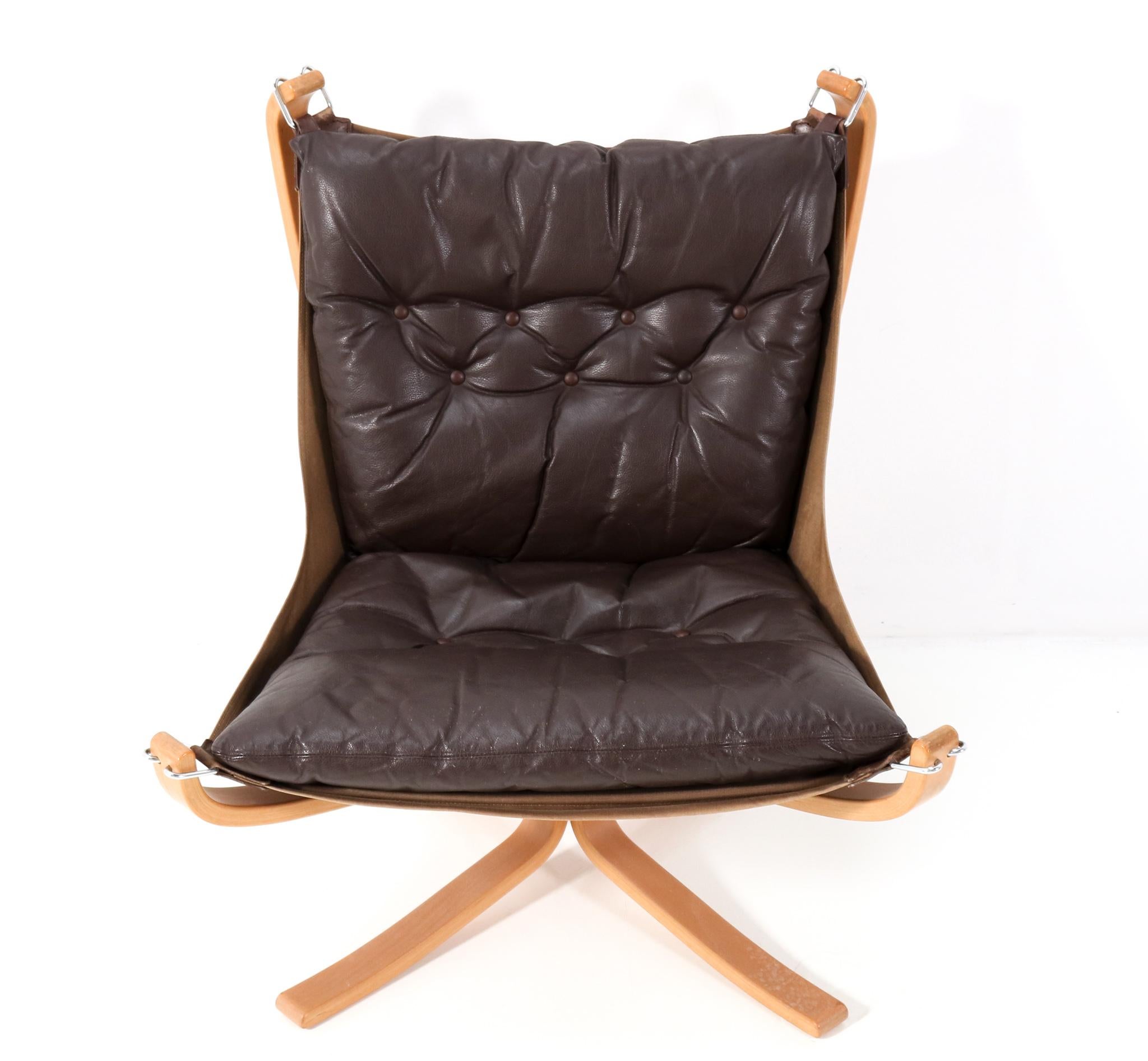 Stunning Mid-Century Modern Falcon lounge chair.
Design by Sigurd Ressell for Vatne Møbler.
Striking Norwegian design from the 1970s
Solid steam bend lacquered beech frame with stretched canvas.
With original brown leather cushion.
This