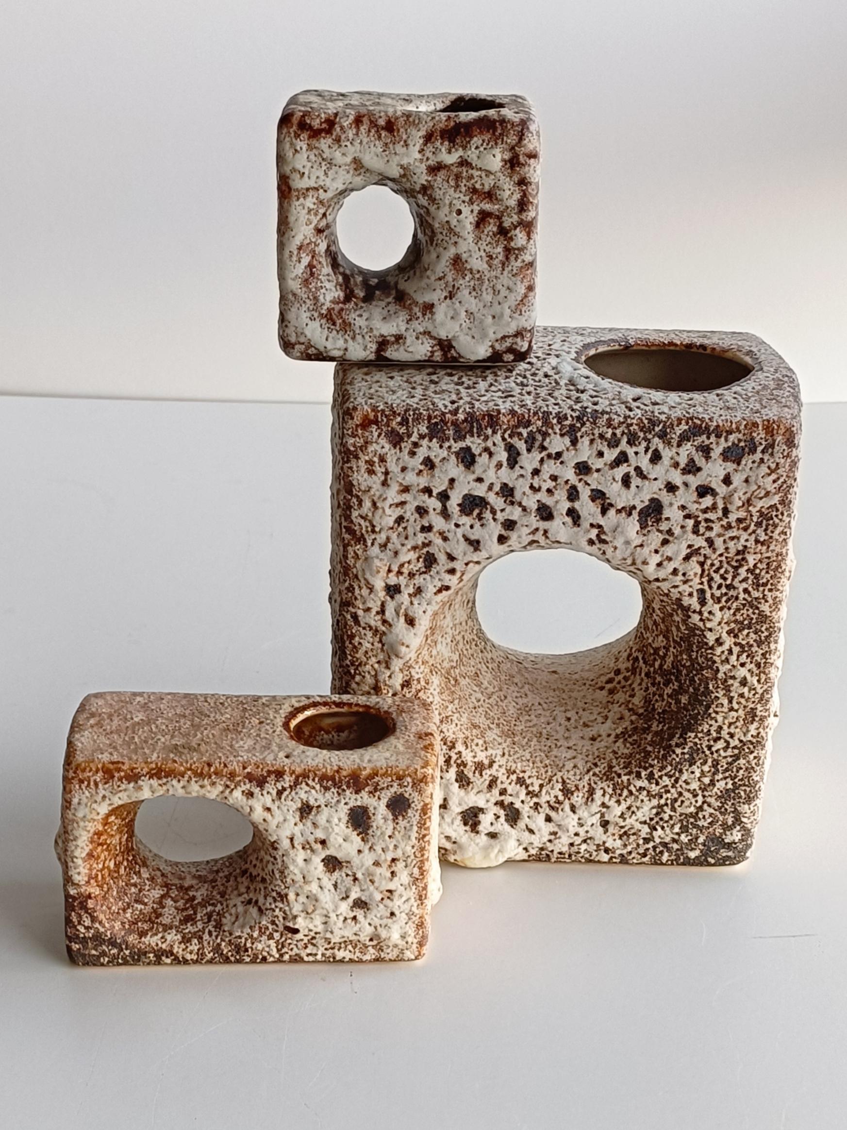 Collection of three small vases designed circa the 1970s in the Netherlands by the brothers Marius & Hugo van Woerden and produced by their own label Vest Keramiek, from the Dutch city of Gouda. Their peculiar physiognomy, with sensual rounded sides