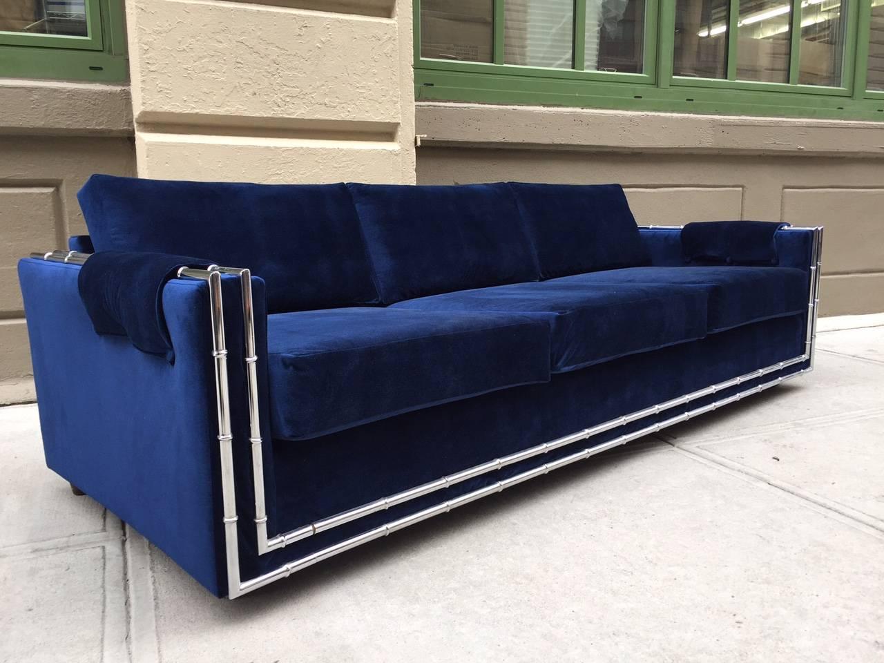 Mid-Century Modern Faux Bamboo Blue Velvet Sofa.  The sofa has a chrome frame with a faux bamboo pattern upholstered in blue velvet.  
Measures: 92