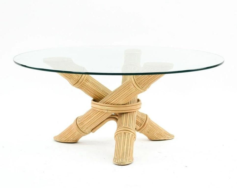 Mid-Century Modern faux bamboo coffee table. Tripod faux bamboo base with a round glass top.