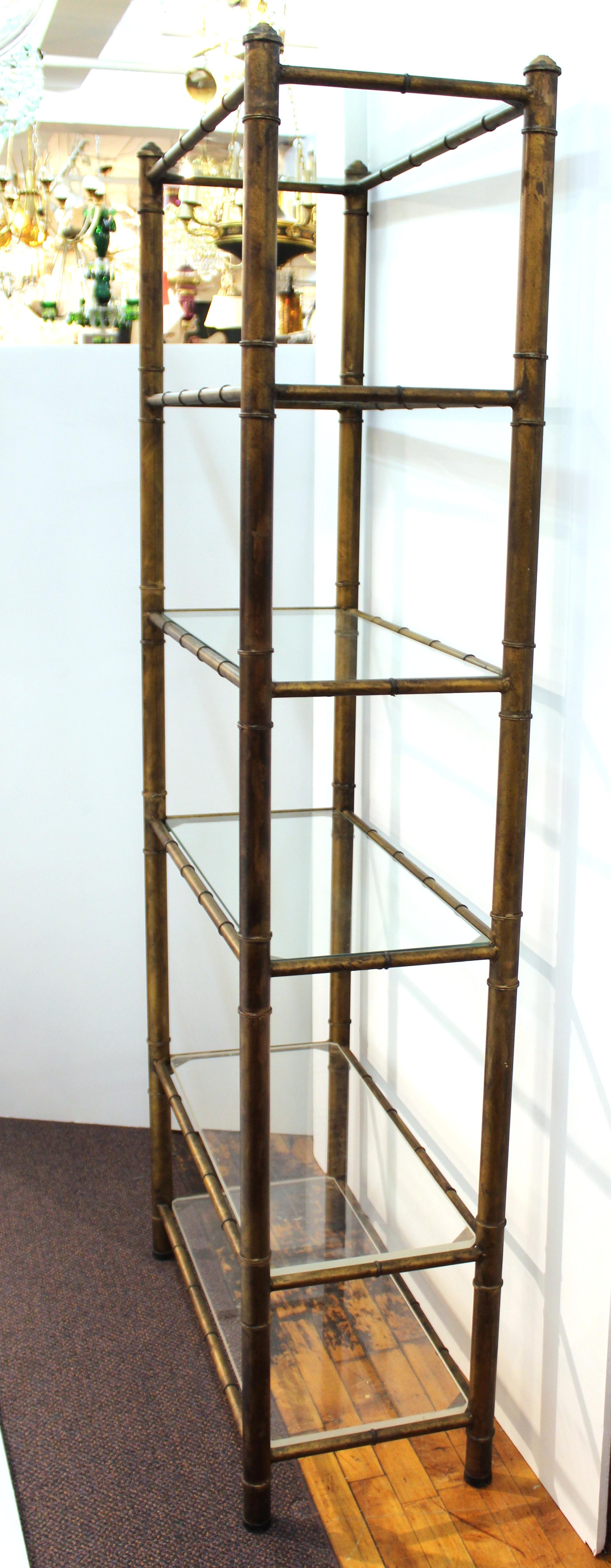 Mid-Century Modern 1970s faux bamboo metal etagere with four glass shelves and two Lucite shelves. The piece is in great vintage condition with minimal age-appropriate wear.
