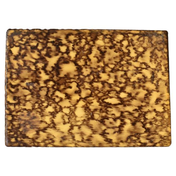 A rectangular faux bois or faux wood decorative trinket box with a lid. This piece is created from an unusual material, and it is hard to tell if it is wood or faux bois. It has a slight texture as though it could be wood. The top and side are in a