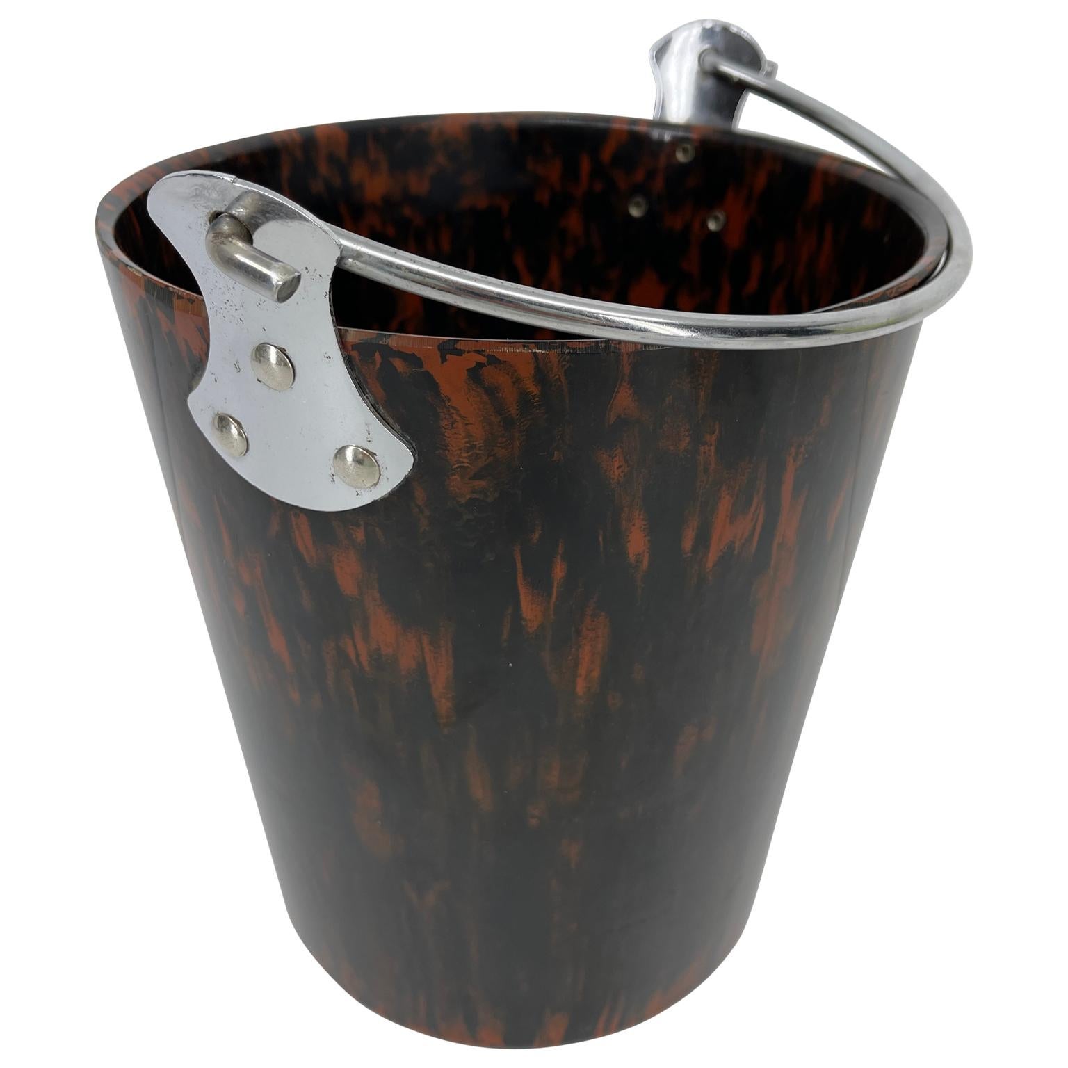 Fun and fantastic, this ice bucket has the tortoise shell look with bright polished chrome handle with ample room for enough ice for the first round of everyone's cocktail. The tortoise shell is bright and glows in the light. The ice bucket is in