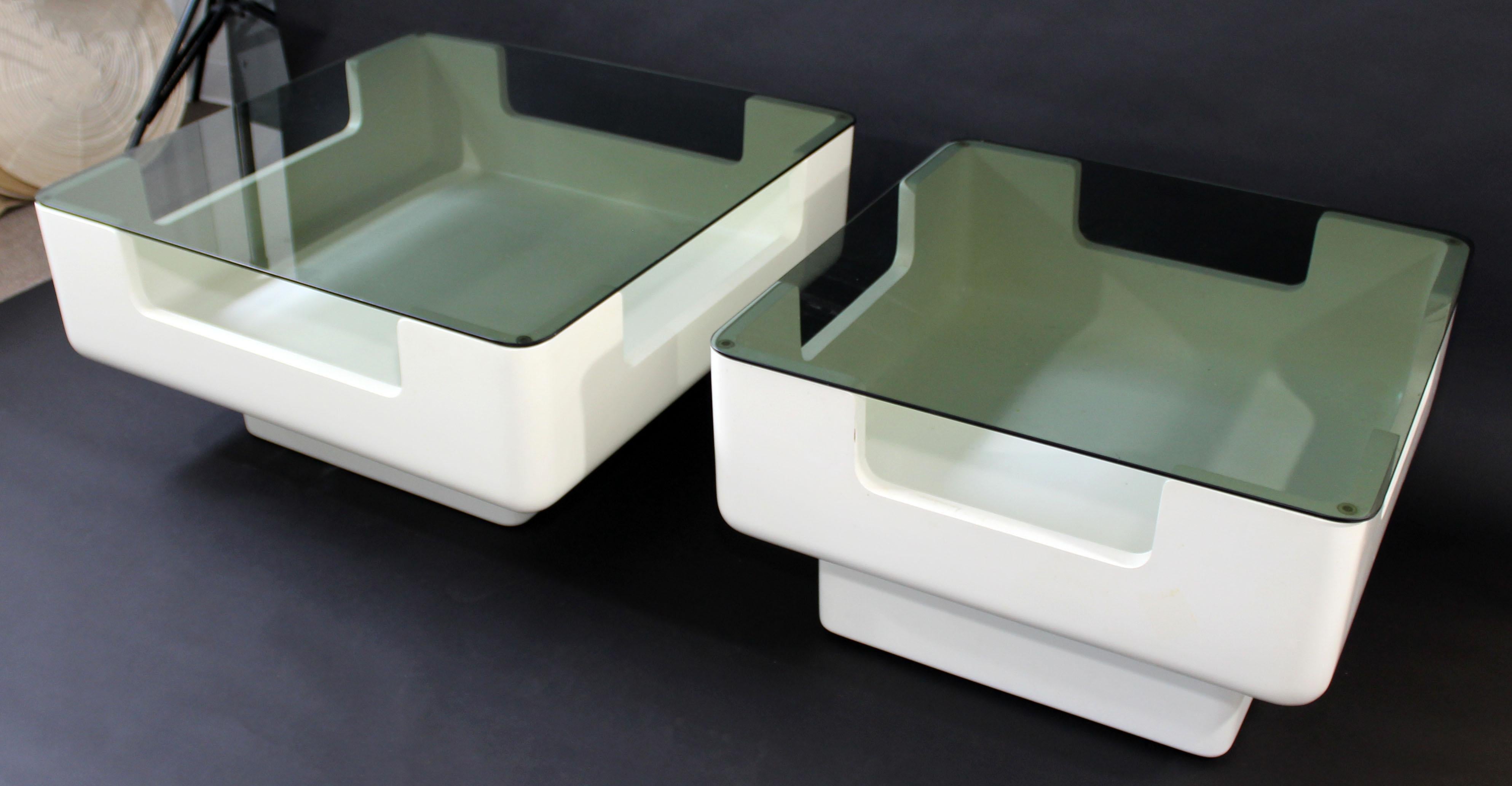 For your consideration is an incredible coffee and side table set, made of molded fiberglass and with smoked glass tops, attributed to Eero Aarnio, circa 1970s, made in Finland. In very good condition. The dimensions of the coffee table are 35.5