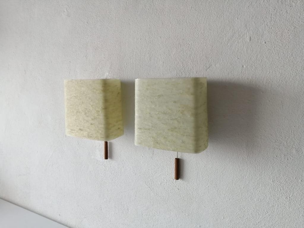 Mid-Century Modern original fiberglass shades pair of sconces, 1950s, Germany

Very elegant and minimalist wall lamps.
There are two switch on-off ropes with teak peaces.


Lamps are in very good condition.

These lamps works with E14