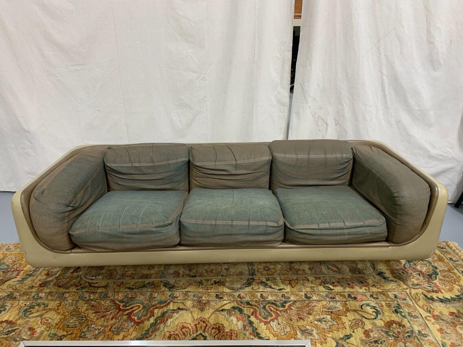 Le Shoppe Too presents a unique fiberglass sofa on acrylic base by William Andrus for Steelcase circa 1970's. Needs to be completely reupholstered. Sofa is structurally strong. Dimensions: 24