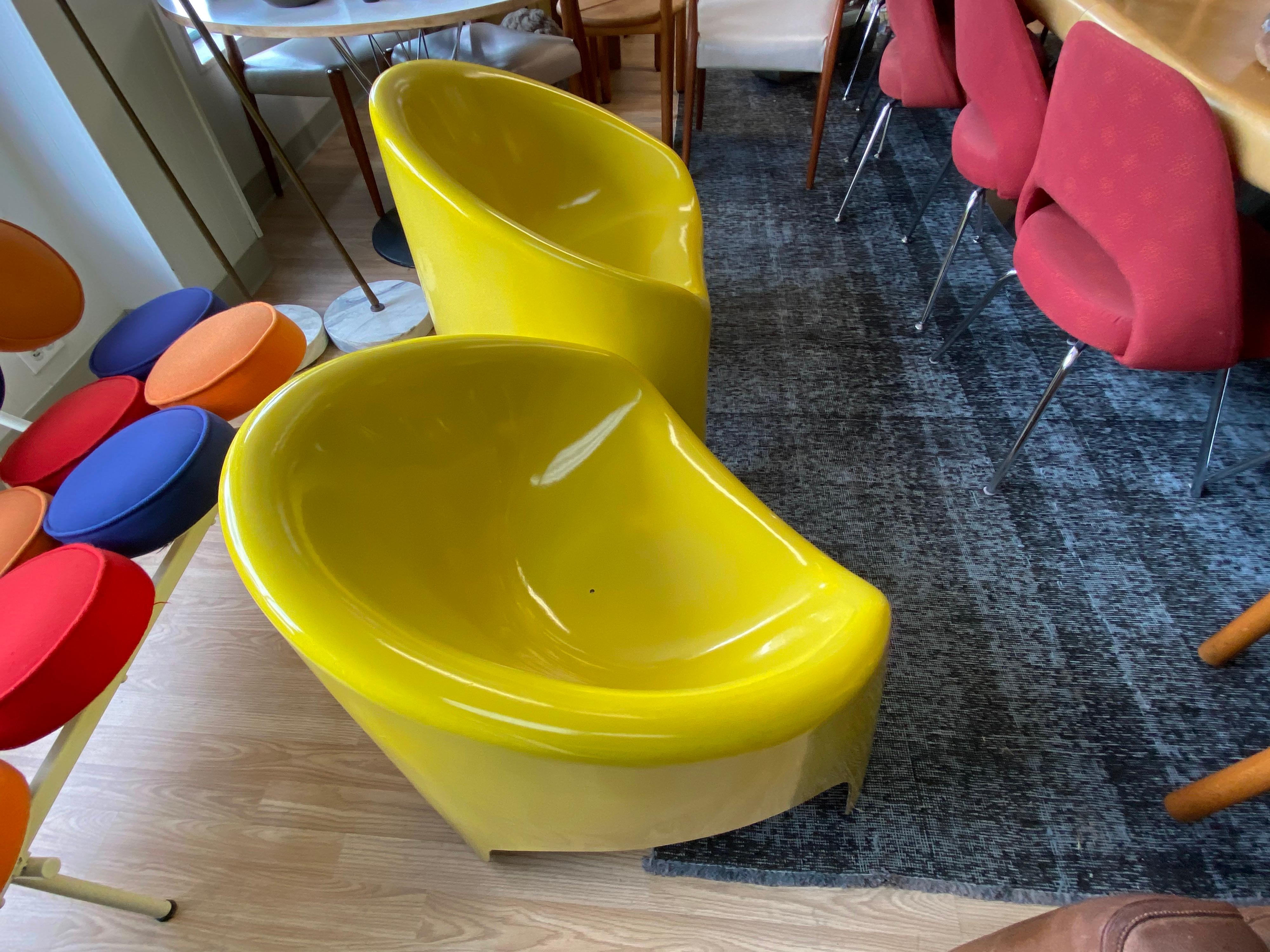 Pair of mid-century yellow fiberglass sculptural lounge chairs made by Fibrella. These vibrant lounge chairs can be used as outdoor patio furniture or indoors. Fibrella, La Baron of Ontario CA produced a line of outdoor furniture from around the