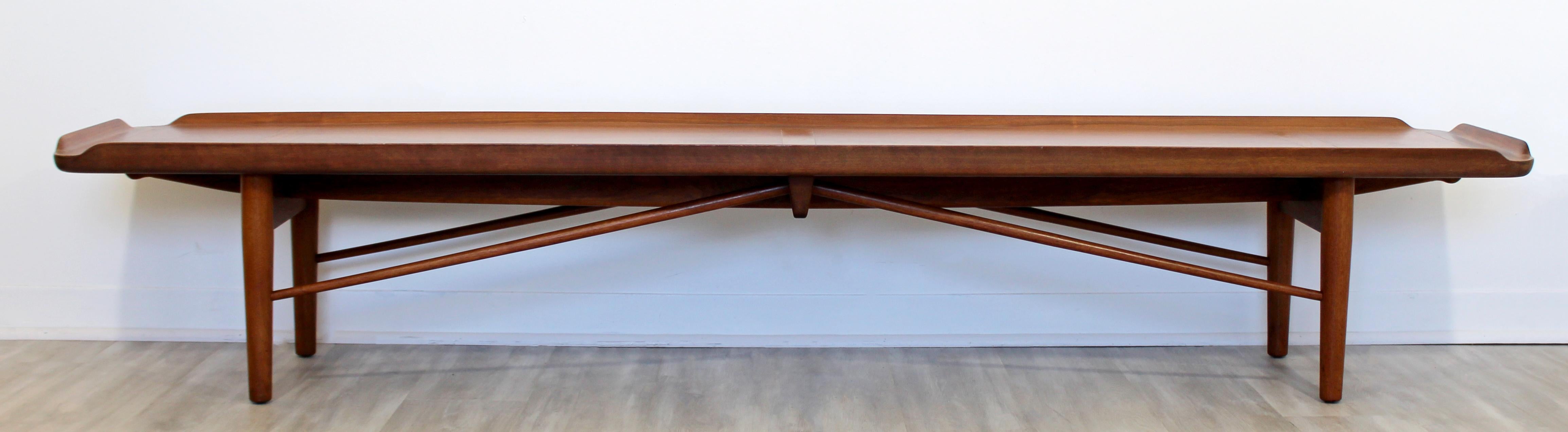 For your consideration is a luxuriously long bench seat or coffee table, made of walnut wood, by Finn Juhl for Baker Furniture, circa 1950s. In excellent vintage condition. The dimensions are 88