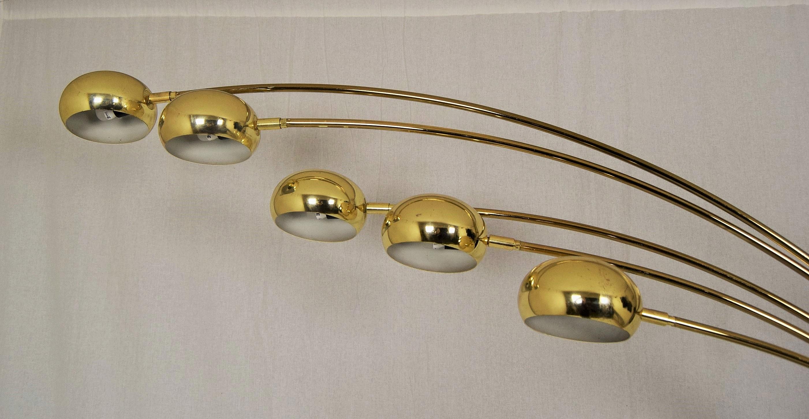 These Guzzini arc lamps are becoming very hard to find and nearly impossible to find in gold with a marble base. Arc floor lamp with five swivel arms and ball shades, shade movement is up and down (vertical) and right and left around axis of arm.