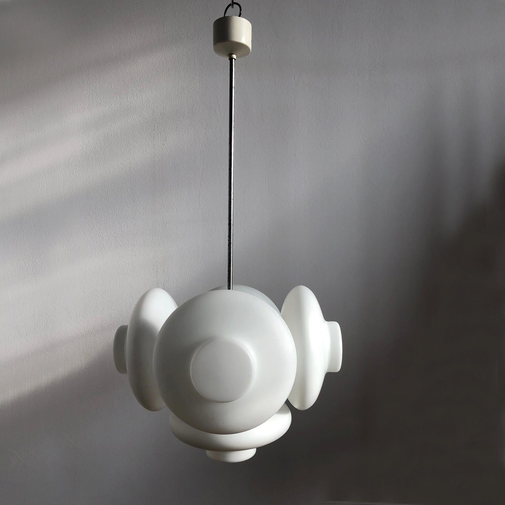 Unusual hanging lamp signed Napako. Five lampshades are made of milk glass and gives warm diffused light. The lamp is rewired. The length of the rod can be customized.