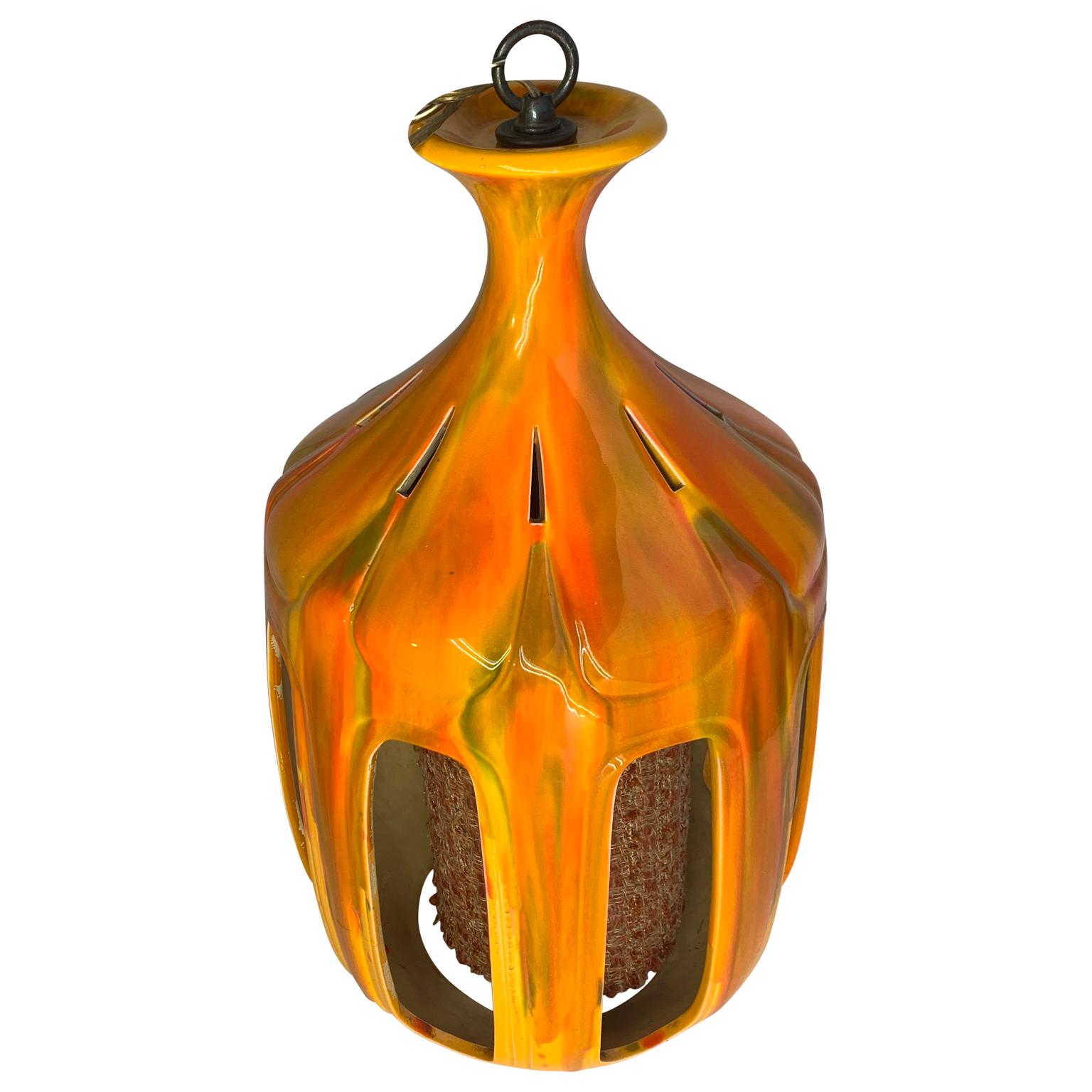 Mid-Century Modern flaming orange ceramic pendant.