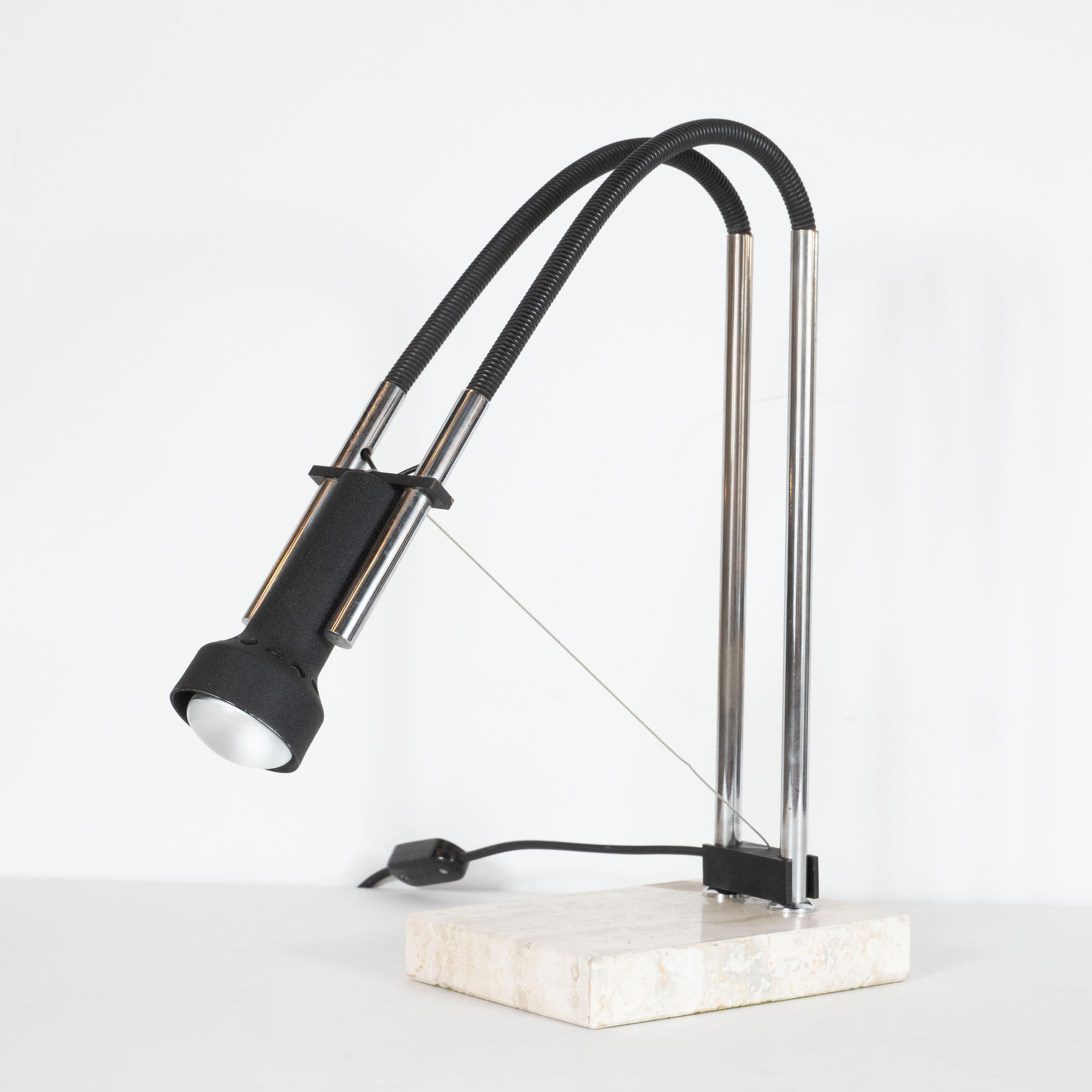 This sophisticated articulating table lamp was realized by influential post-war Italian lighting designer Angelo Lelii for Arredoluce, circa 1975. The lamp's single bulb is encased in a black enameled brass shade. This fixture is flanked by two